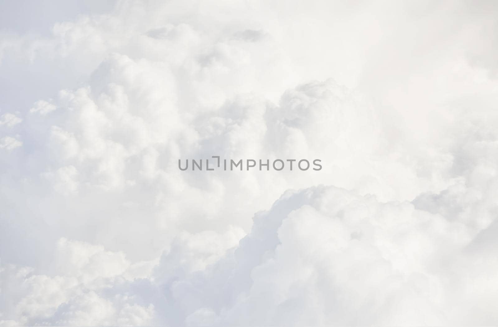 Sky with clouds, a view from an aeroplane above the clouds. Abstract nature background with clouds in light tonality. White cumulus clouds