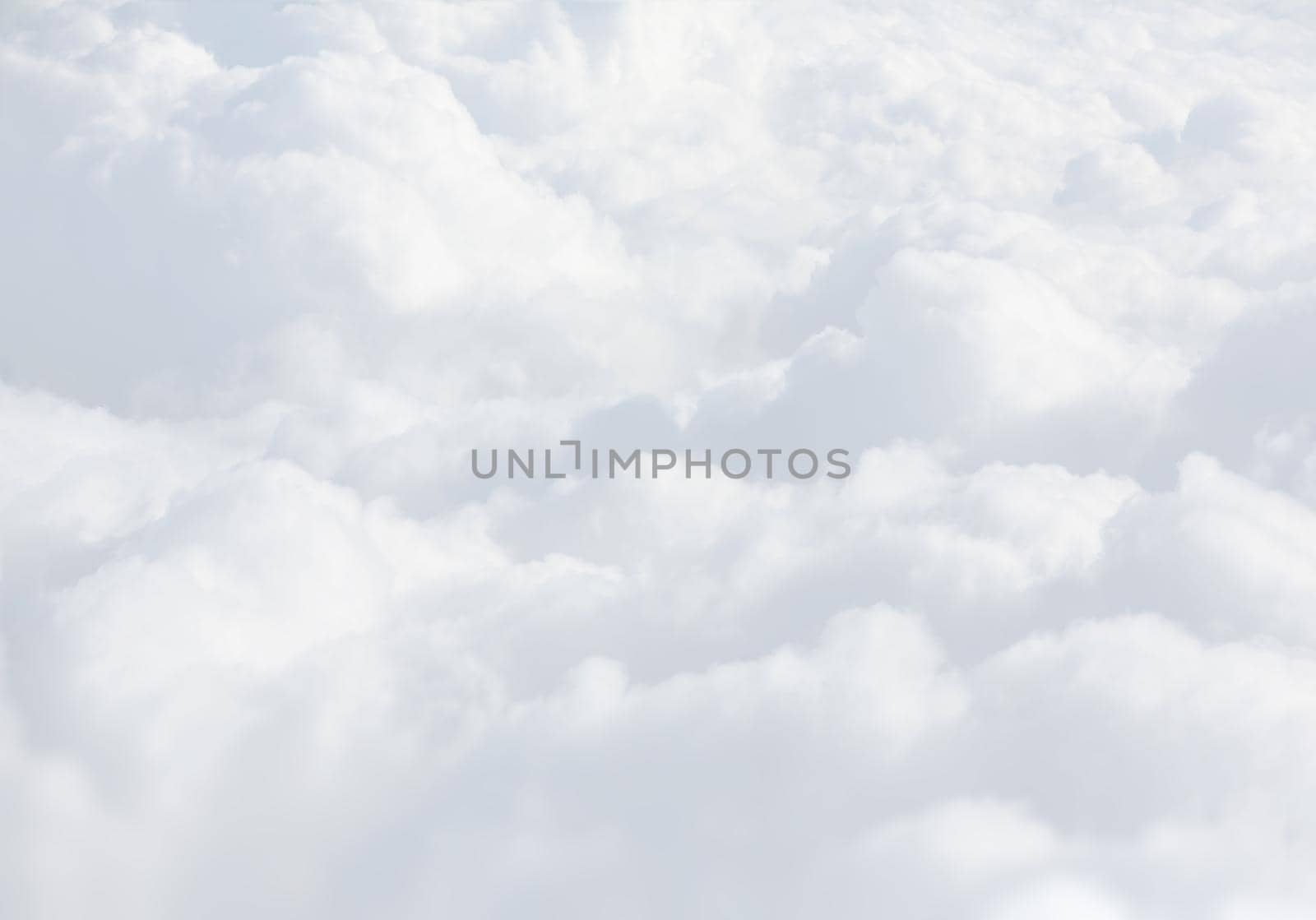 Sky with clouds, a view from an aeroplane above the clouds. Abstract nature background with clouds in light tonality. White cumulus clouds