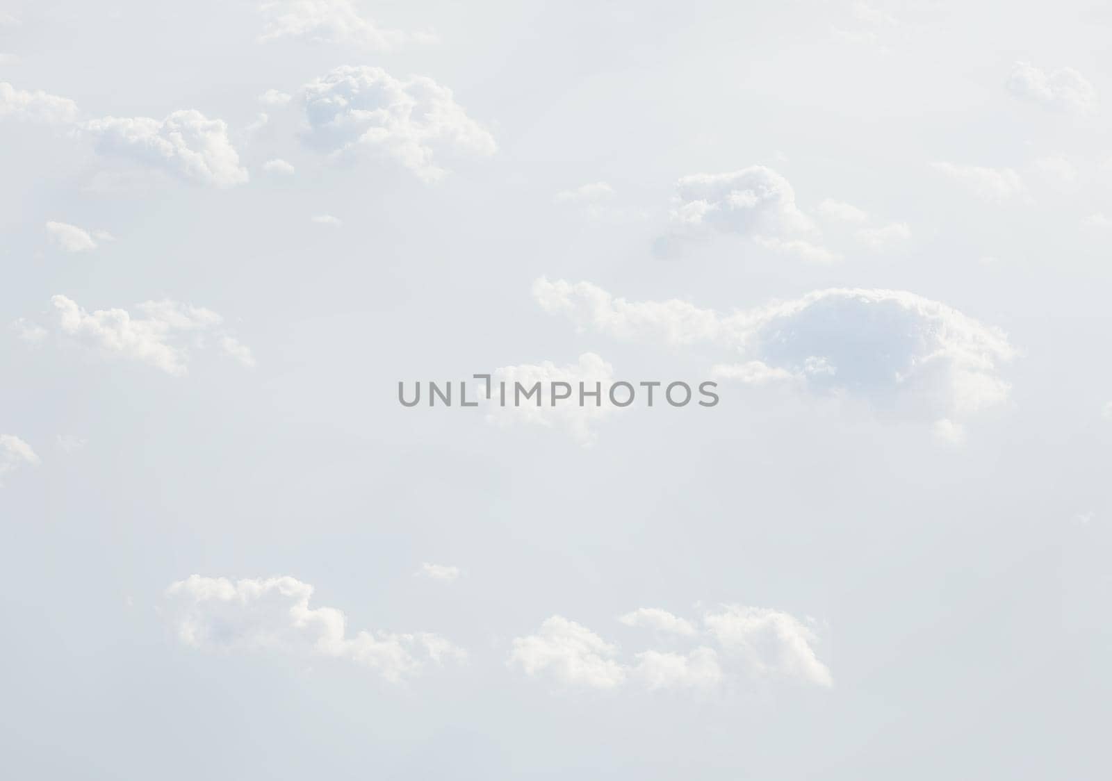 Sky with clouds, a view from an aeroplane above the clouds. Abstract nature background with clouds in light tonality. White cumulus clouds