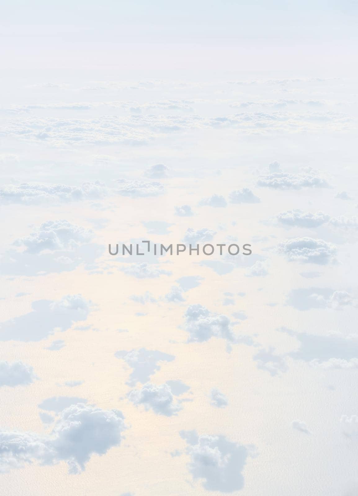 Sky with clouds, a view from an aeroplane above the clouds. Abstract nature background with clouds in light tonality. White cumulus clouds