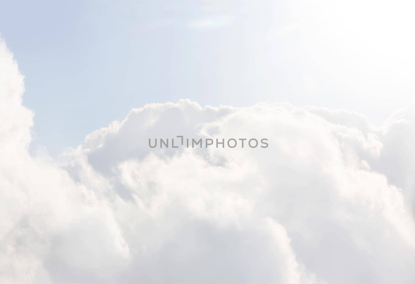 Sky with clouds, a view from an aeroplane above the clouds. Abstract nature background with clouds in light tonality. White cumulus clouds