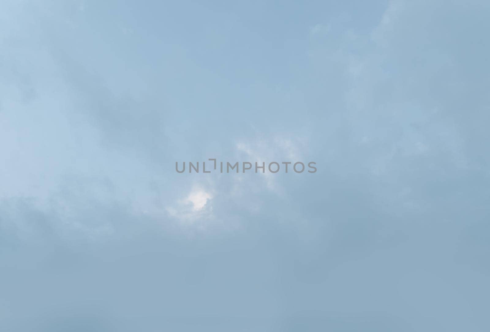Natural sky background with clouds in light tonality. Abstract nature image for background use.