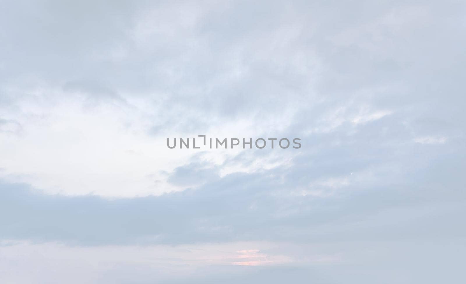 Natural sky background with clouds in light tonality. Abstract nature image for background use.
