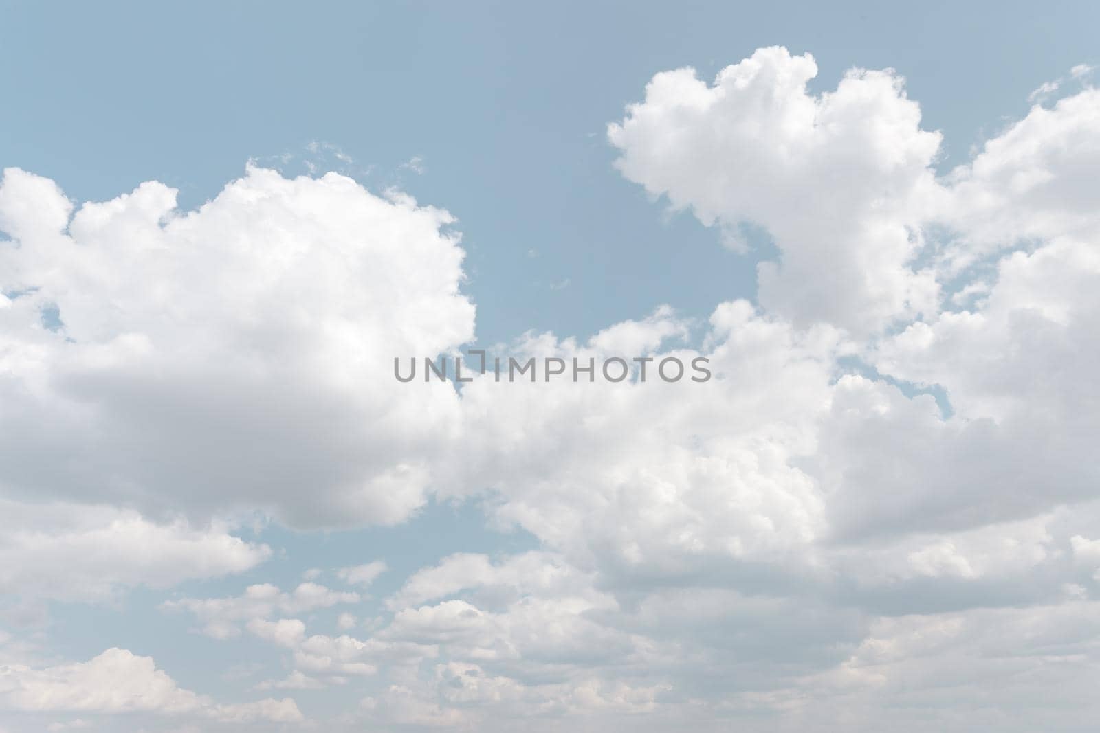 Natural sky background with clouds in light tonality. Abstract nature image for background use.