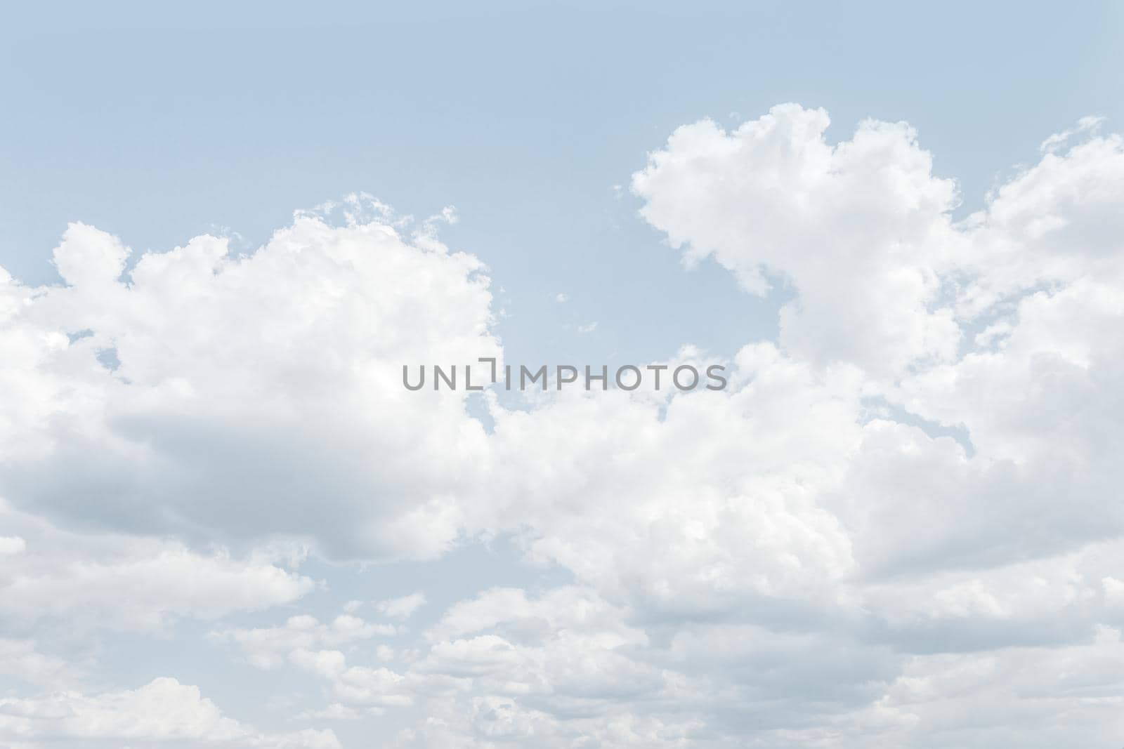 Natural sky background with clouds in light tonality. Abstract nature image for background use.