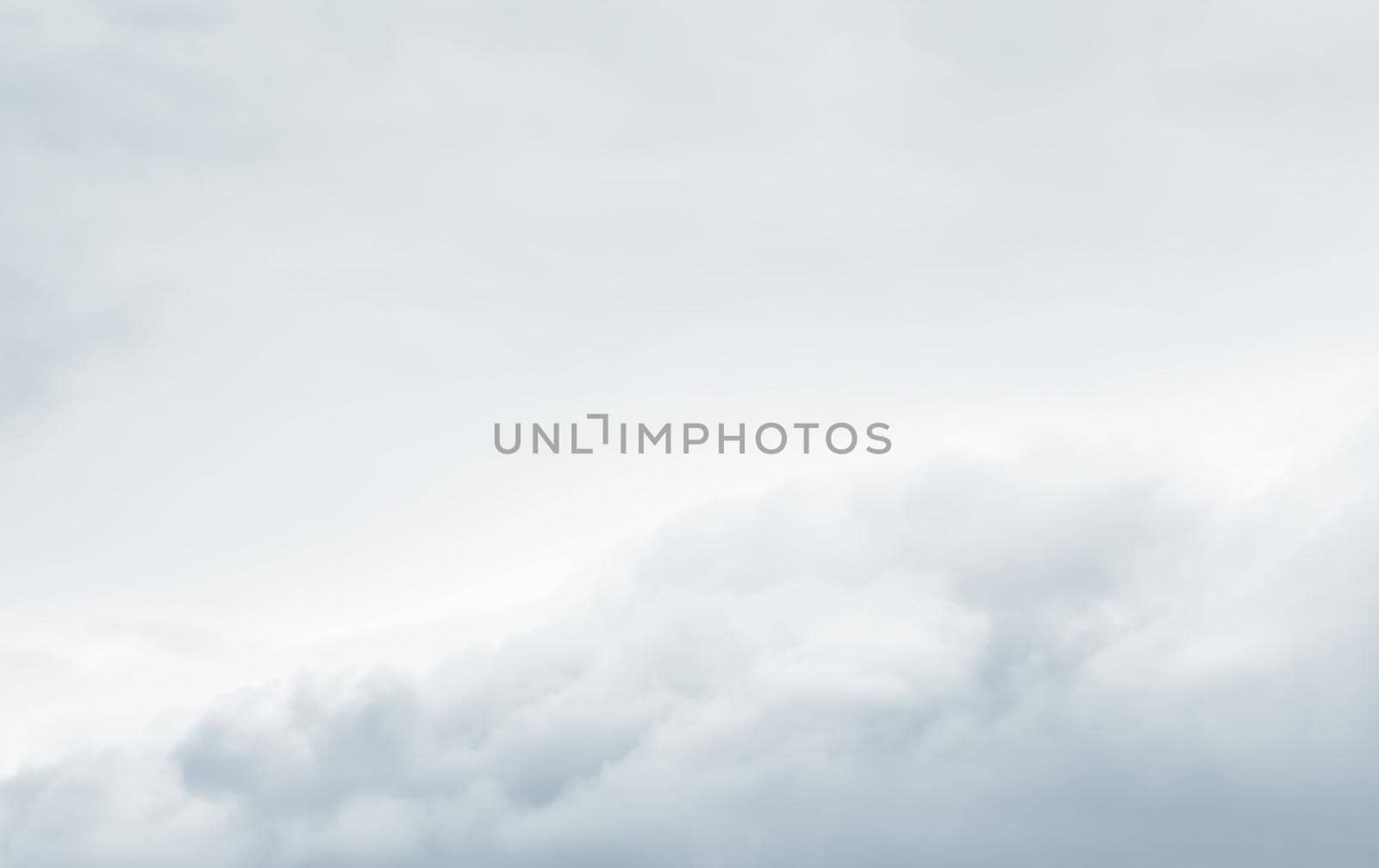 Natural sky background with clouds in light tonality. Abstract nature image for background use.