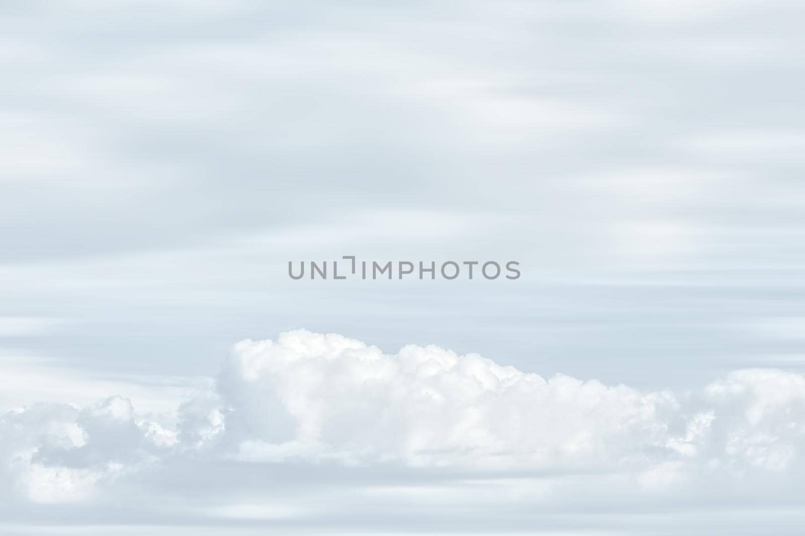 Natural sky background with clouds in light tonality. Abstract nature image for background use.