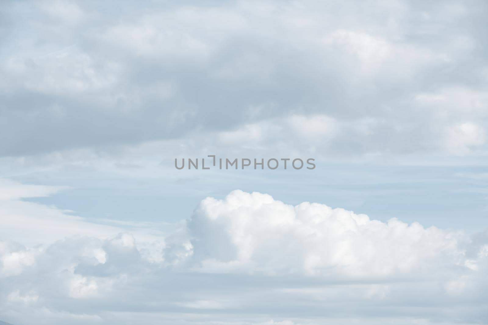 Natural sky background with clouds in light tonality. Abstract nature image for background use.