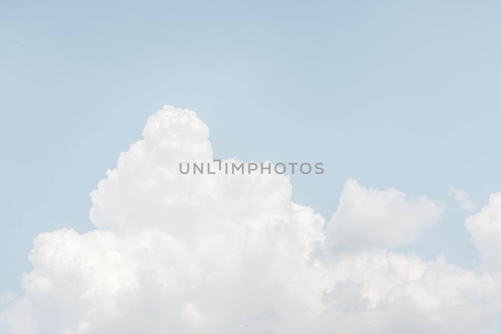 Natural sky background with clouds in light tonality. Abstract nature image for background use.