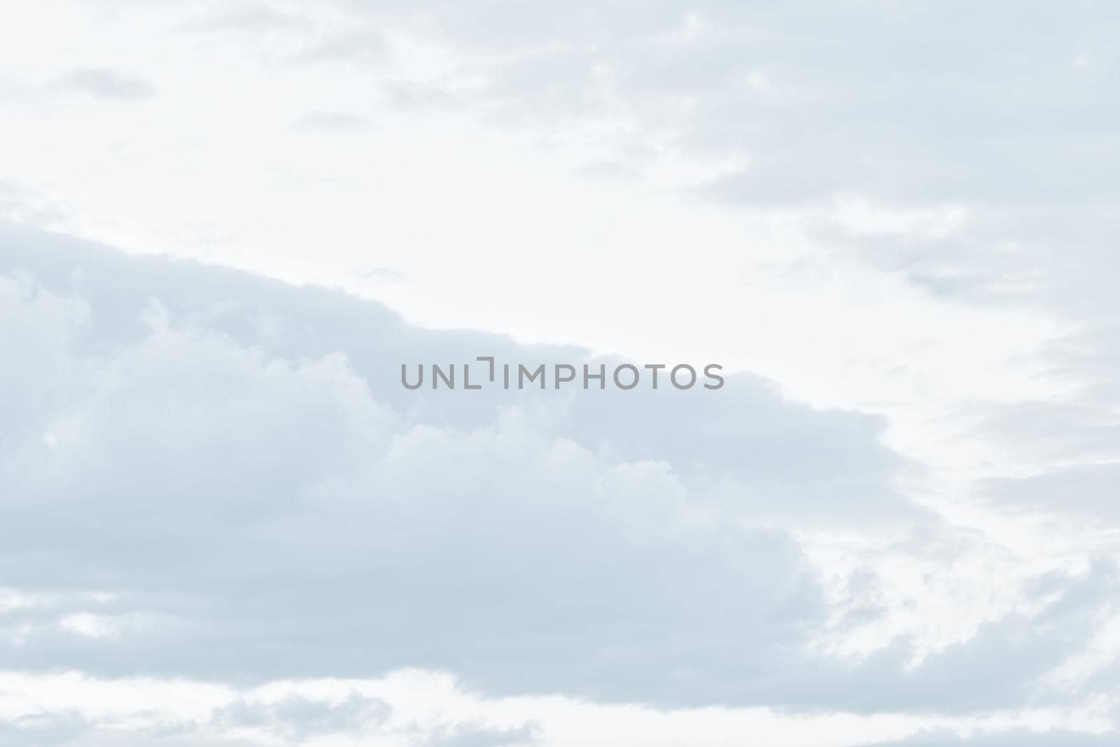 Natural sky background with clouds in light tonality. Abstract nature image for background use.
