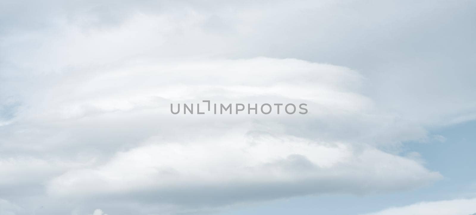 Natural sky background with clouds in light tonality. Abstract nature image for background use.