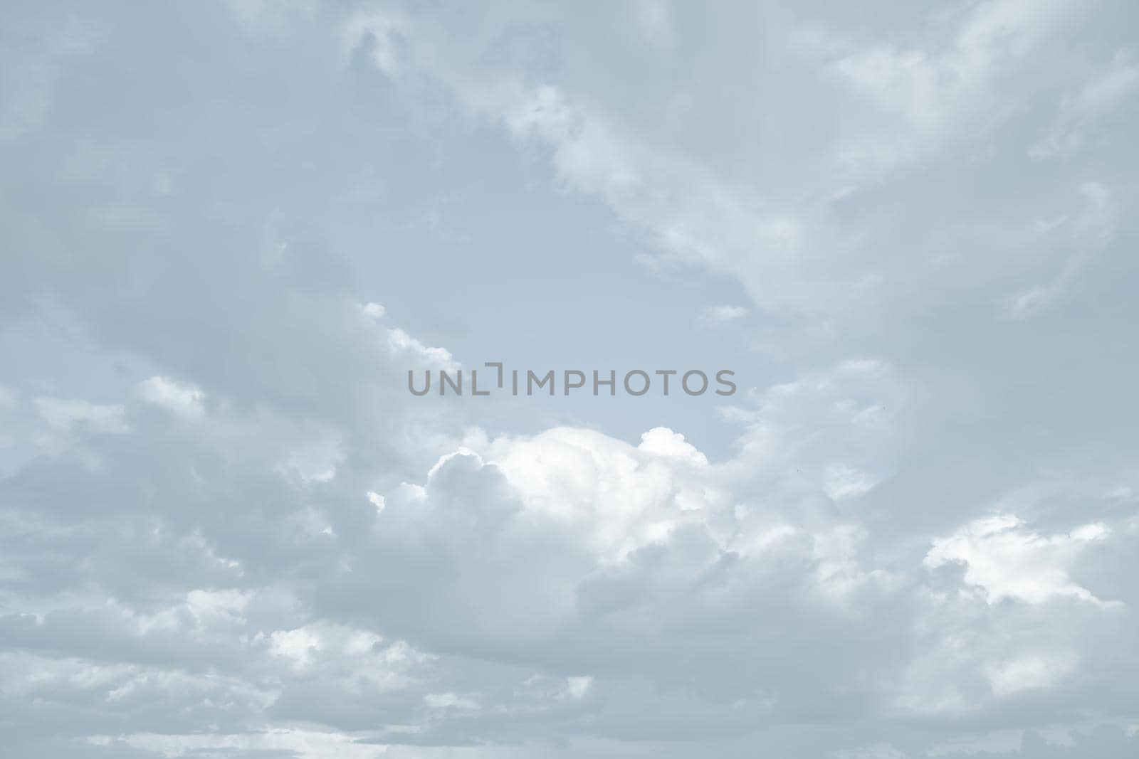 Natural sky background with clouds in light tonality. Abstract nature image for background use.