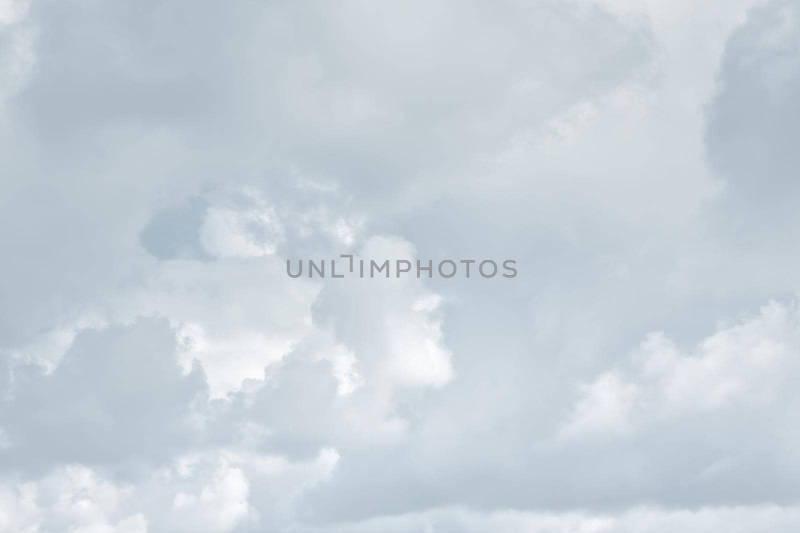 Natural sky background with clouds in light tonality. Abstract nature image for background use.