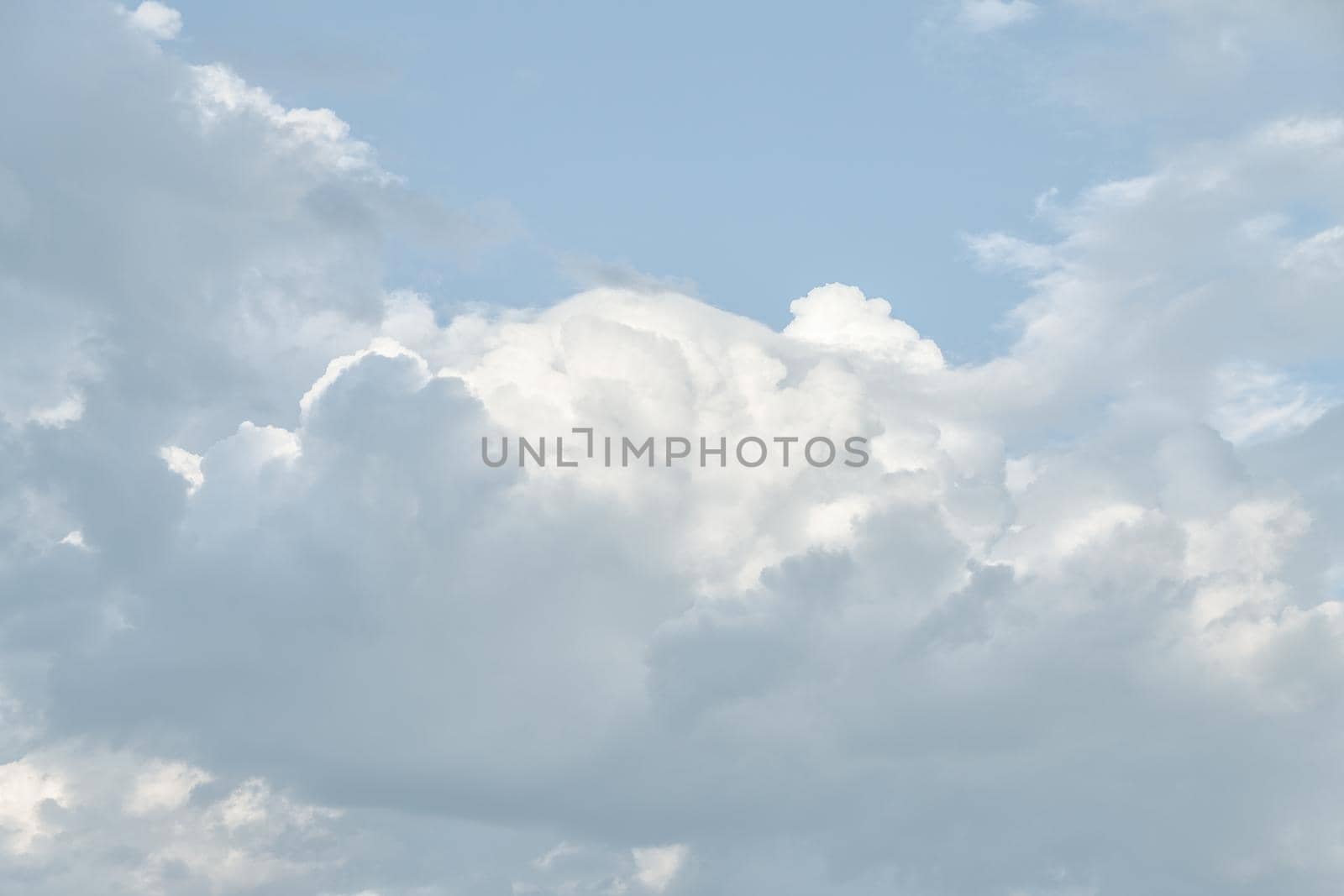 Natural sky background with clouds in light tonality. Abstract nature image for background use.