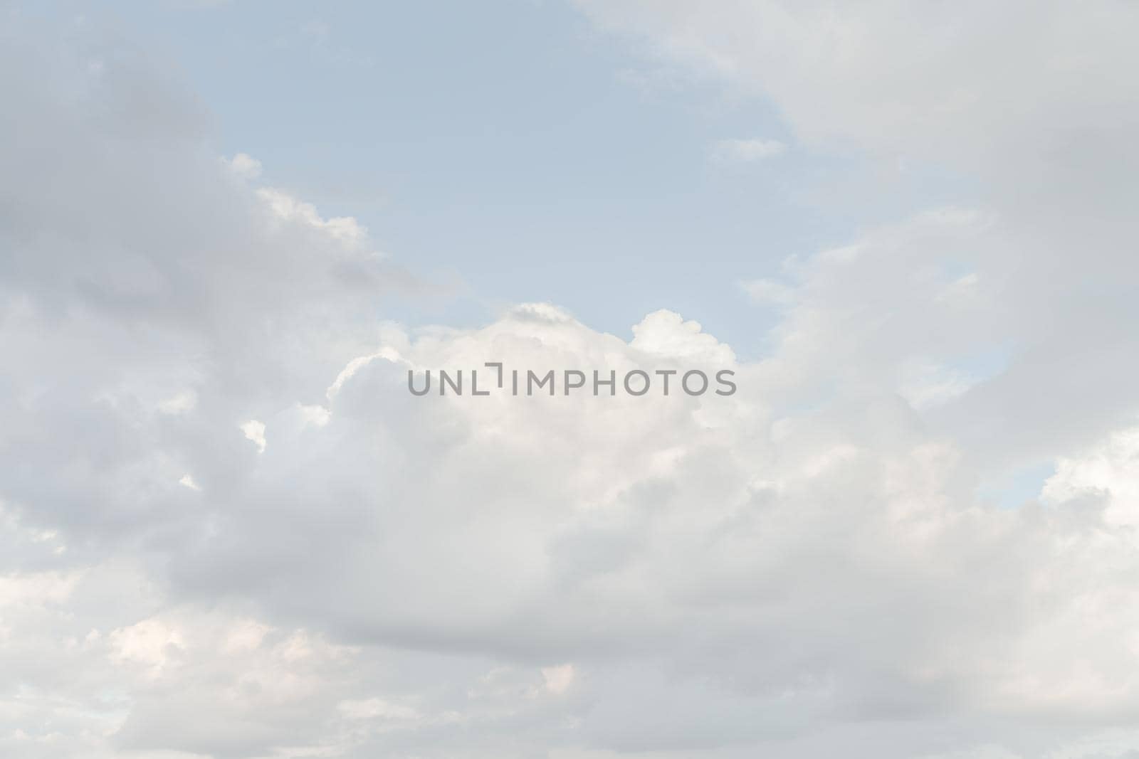 Natural sky background with clouds in light tonality. Abstract nature image for background use.