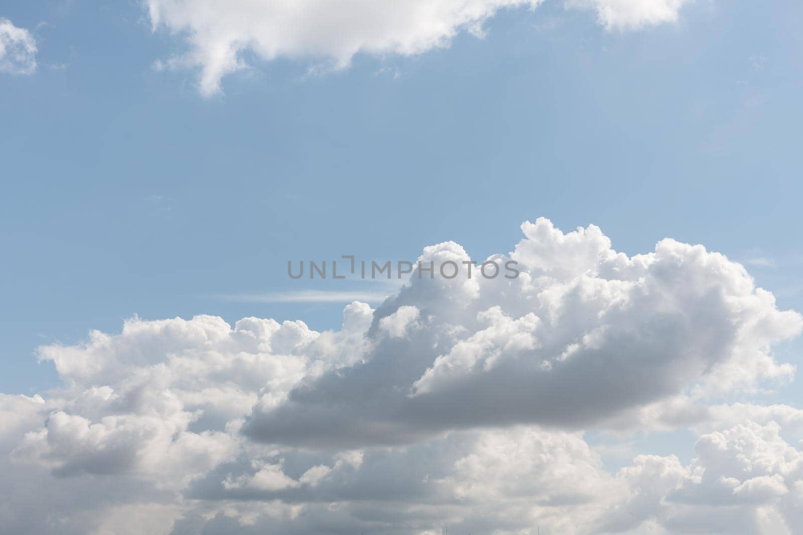 Natural sky background with clouds in light tonality. Abstract nature image for background use.