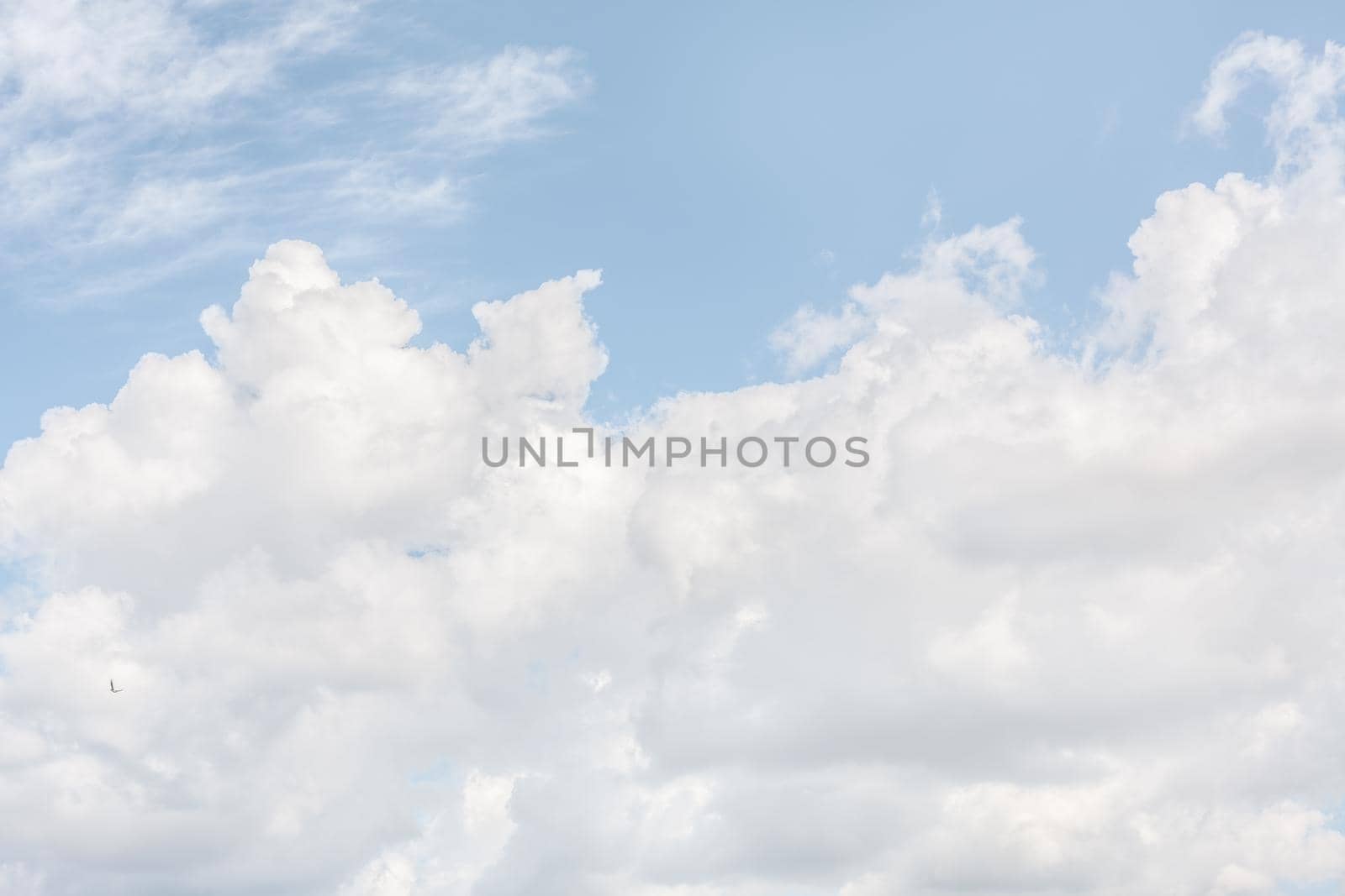 Natural sky background with clouds in light tonality. Abstract nature image for background use.
