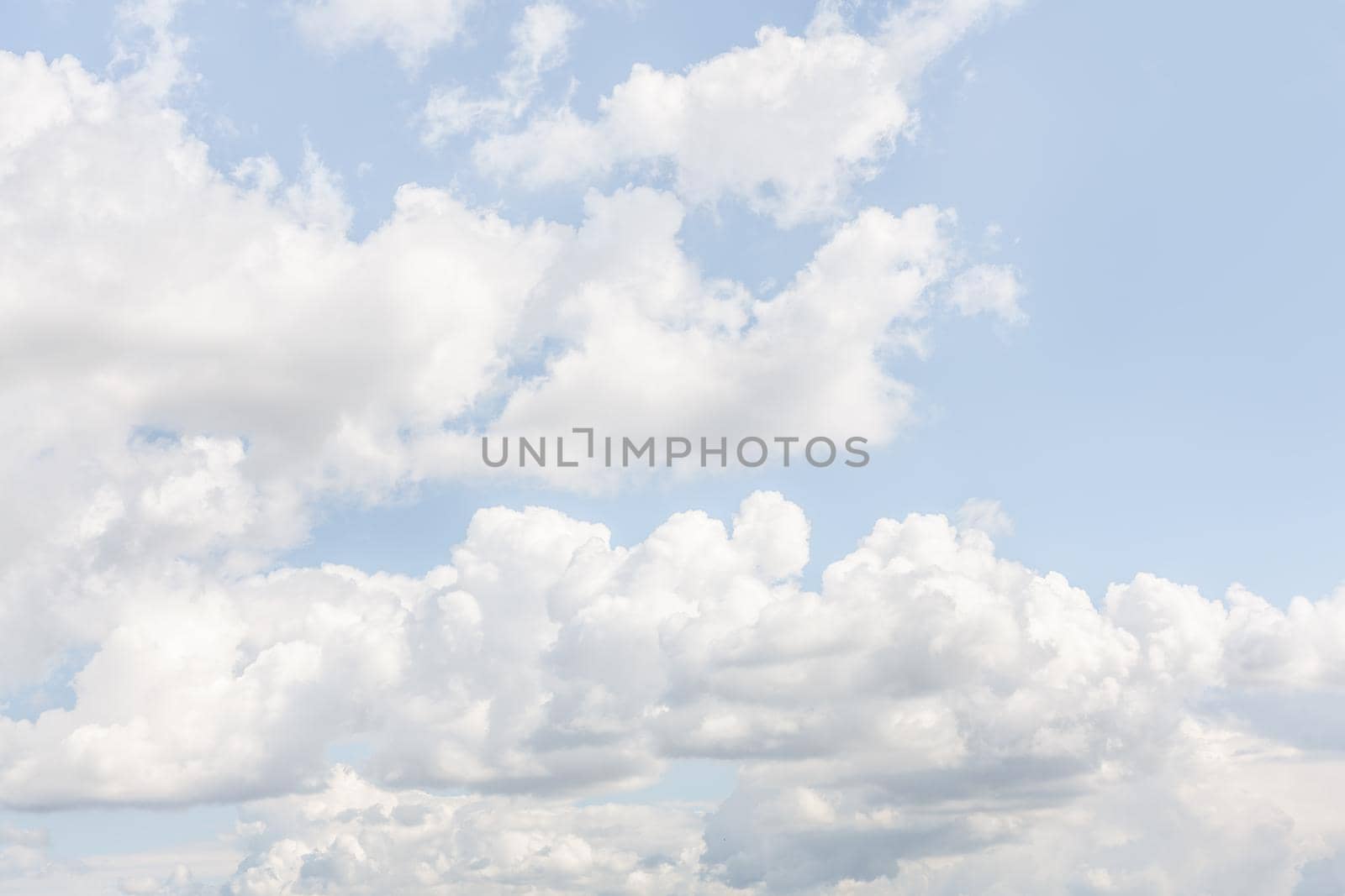 Natural sky background with clouds in light tonality. Abstract nature image for background use.