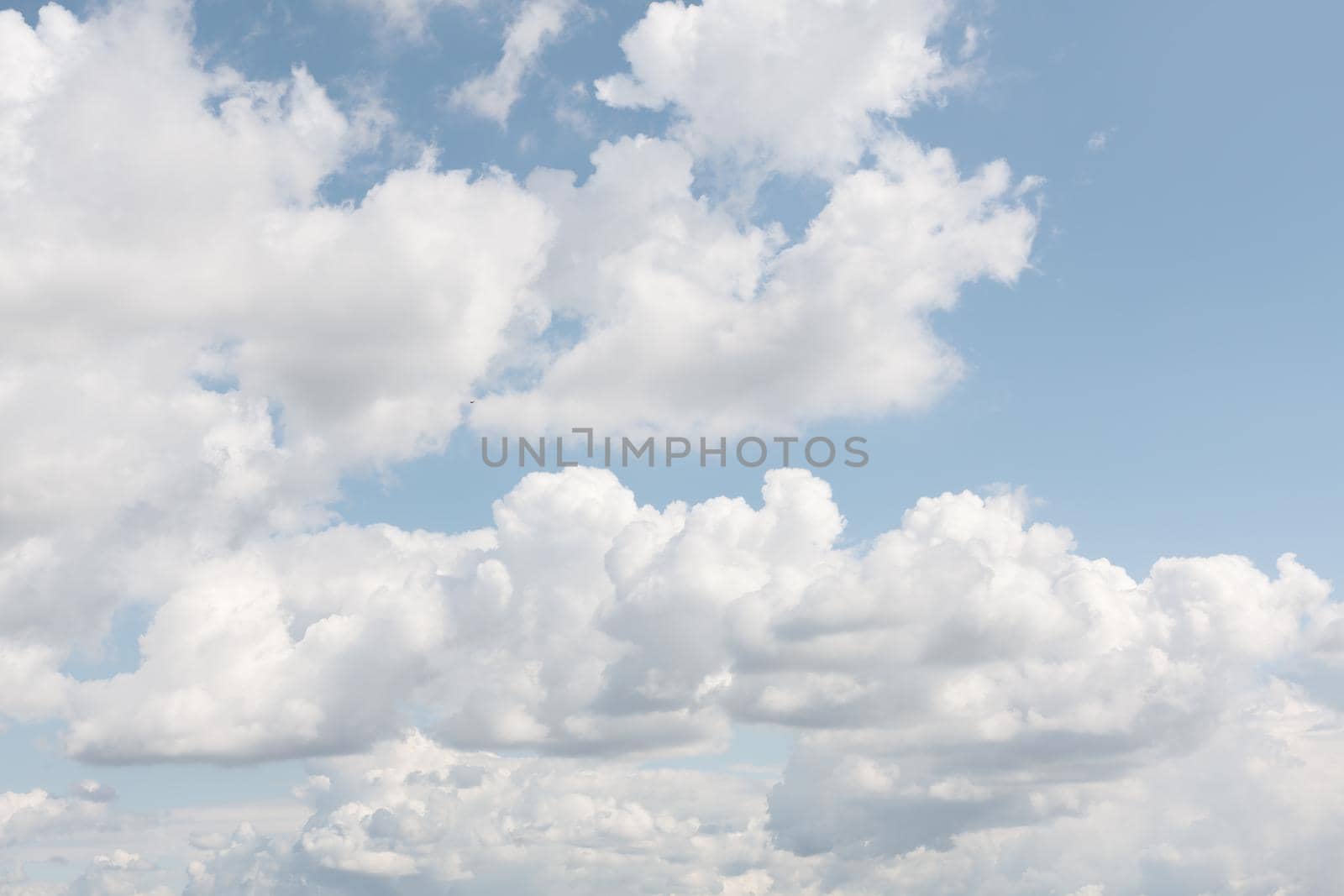 Natural sky background with clouds in light tonality. Abstract nature image for background use.