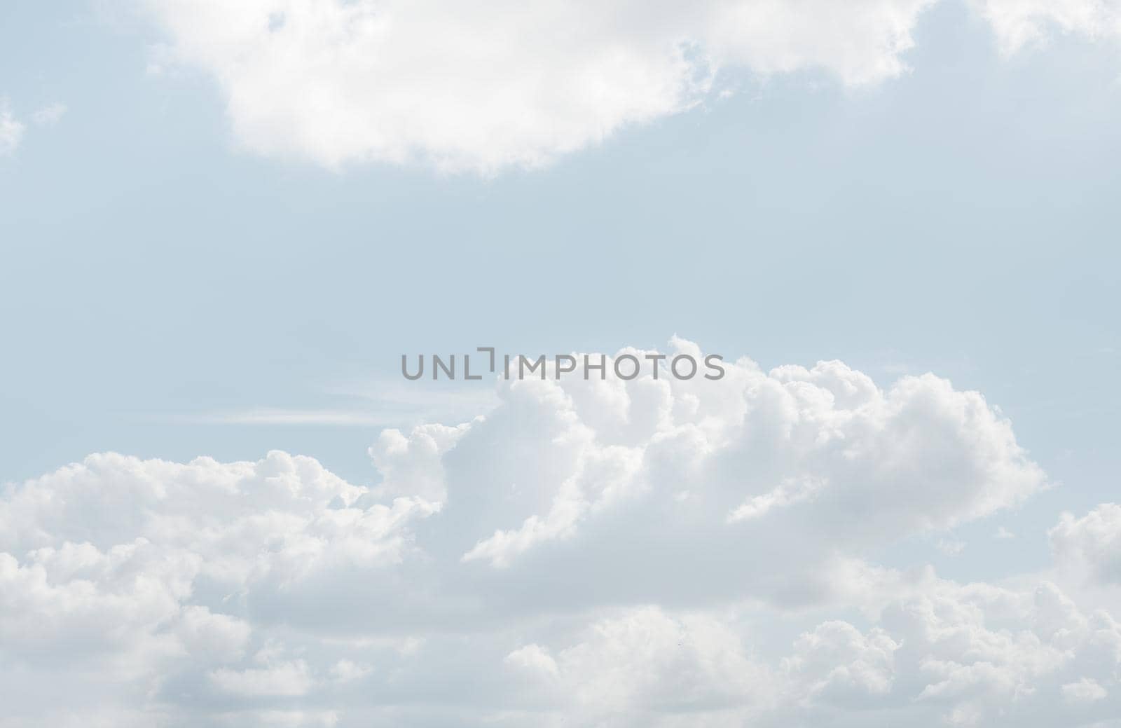 Natural sky background with clouds in light tonality. Abstract nature image for background use.