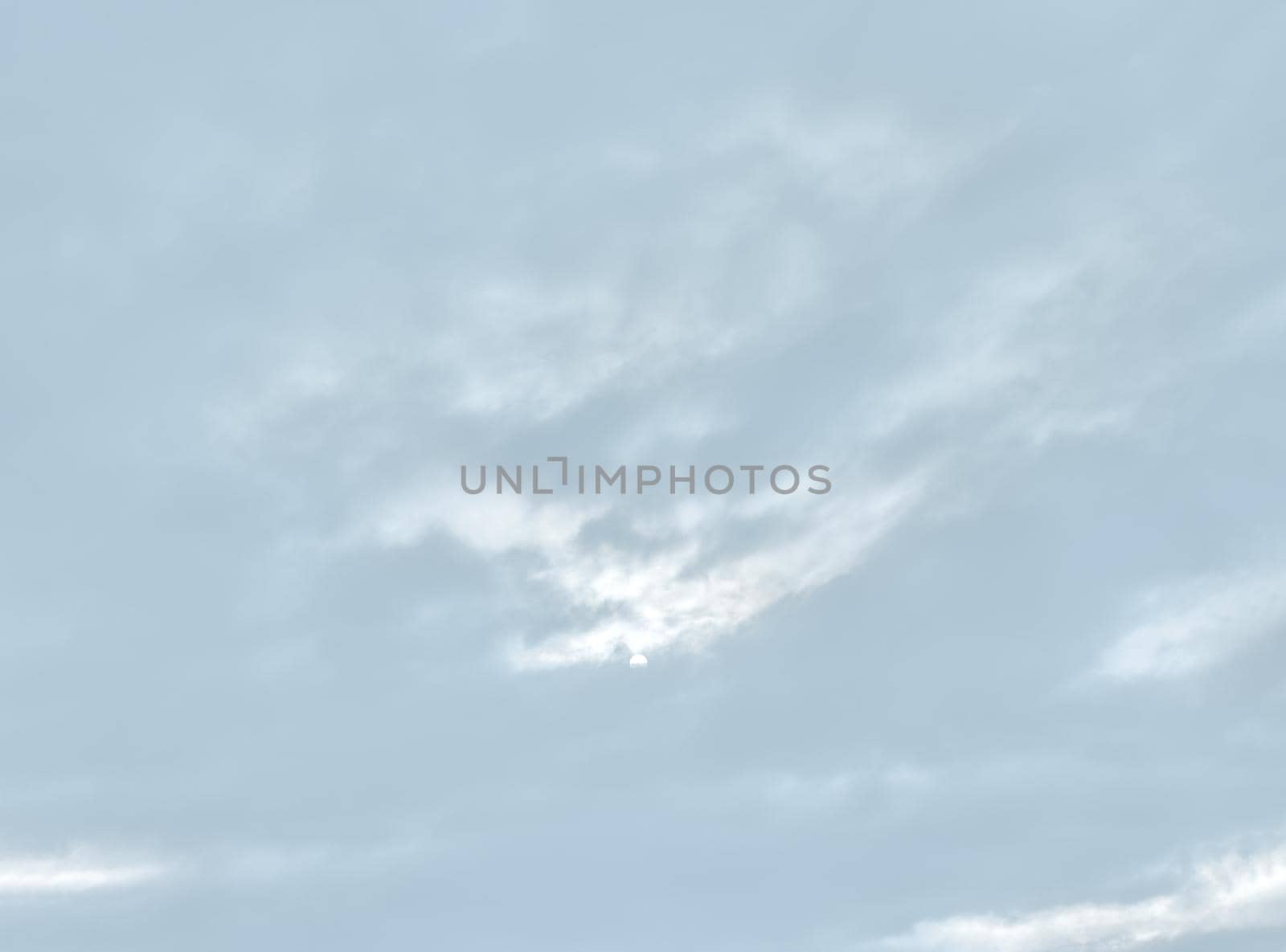 Natural sky background with clouds in light tonality. Abstract nature image for background use.