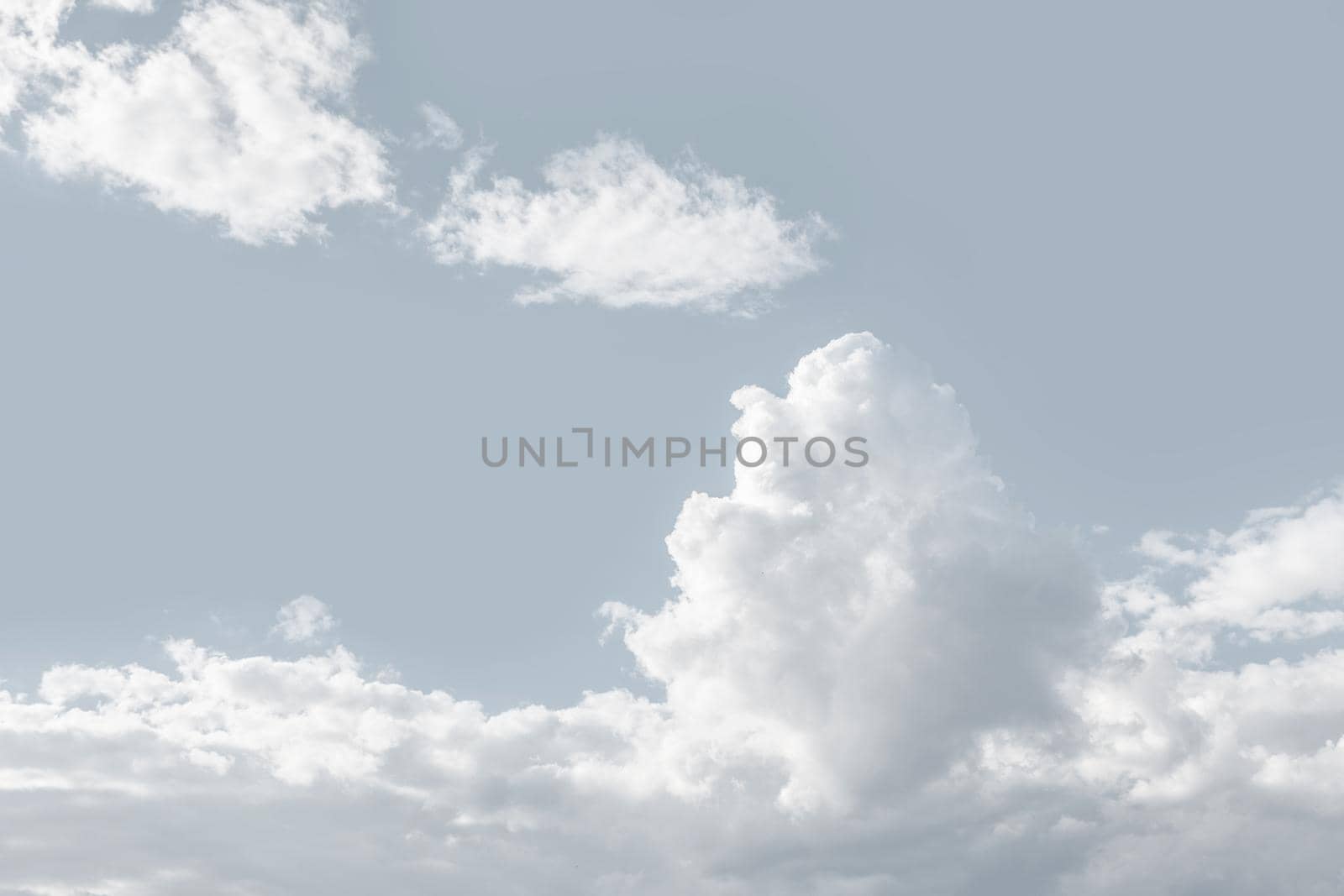 Natural sky background with clouds in light tonality. Abstract nature image for background use.