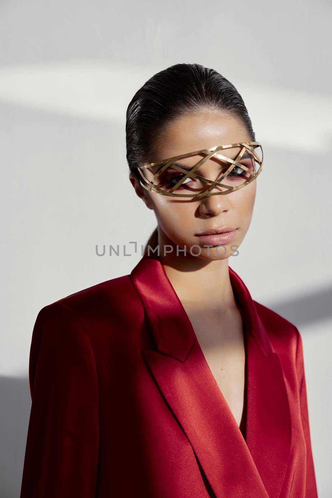 model in red blazer with accessory on face cropped view. High quality photo