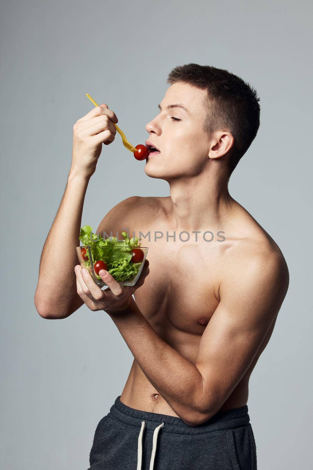 Man eat salad healthy food energy workout bodybuilder. High quality photo