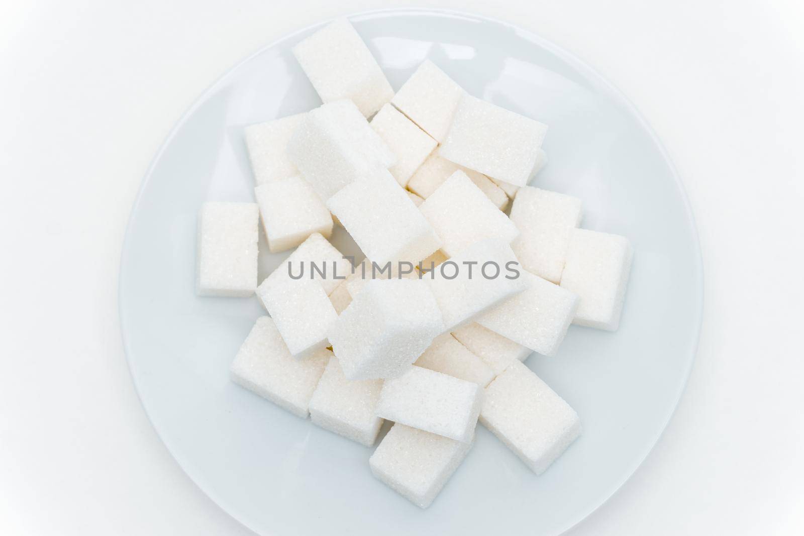 refined sugar on a plate calories sweets. High quality photo
