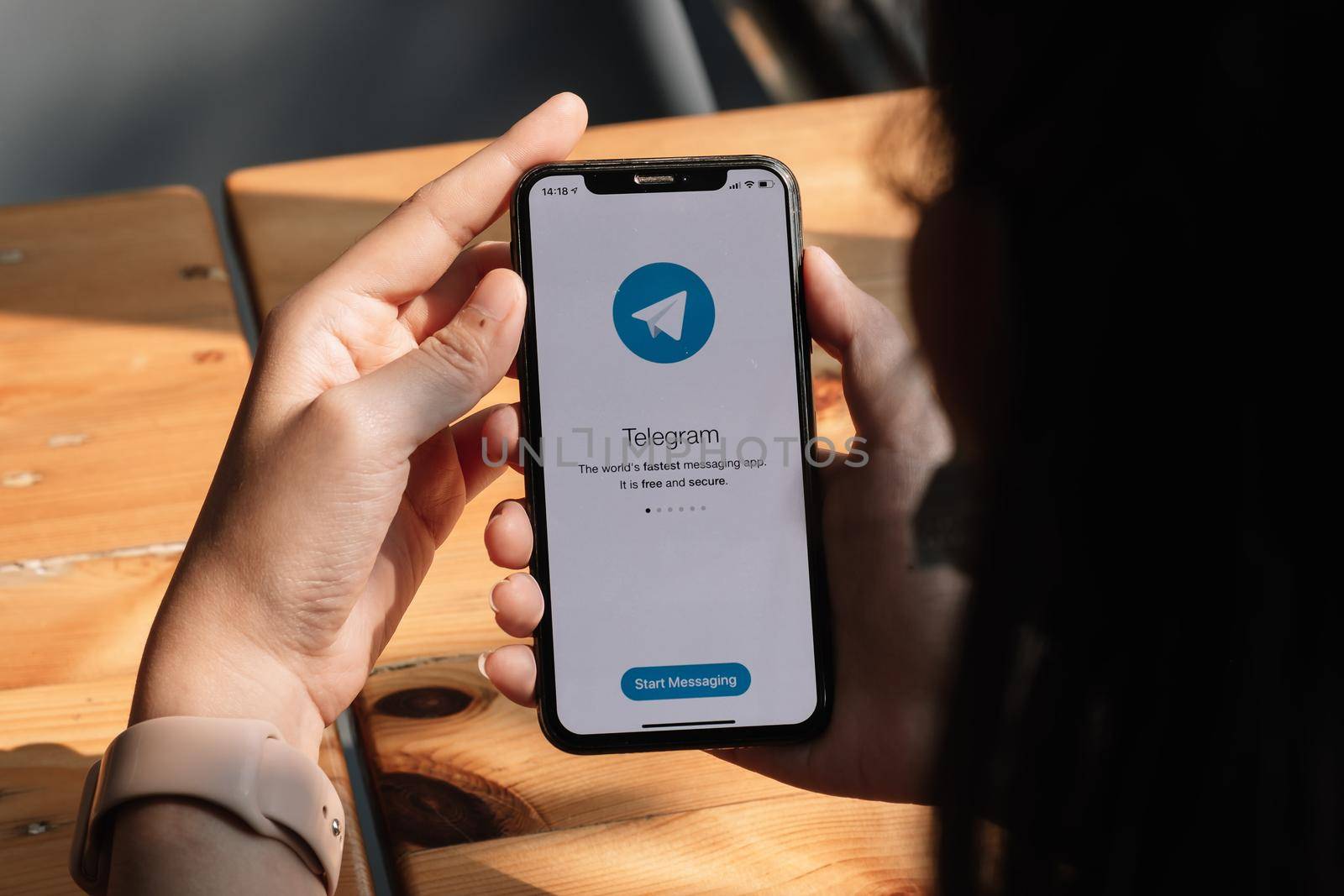 CHIANG MAI, THAILAND, MAR 7, 2021 : Woman hand holding iPhone X with social networking service Telegram on the screen. iPhone 10 was created and developed by the Apple inc.