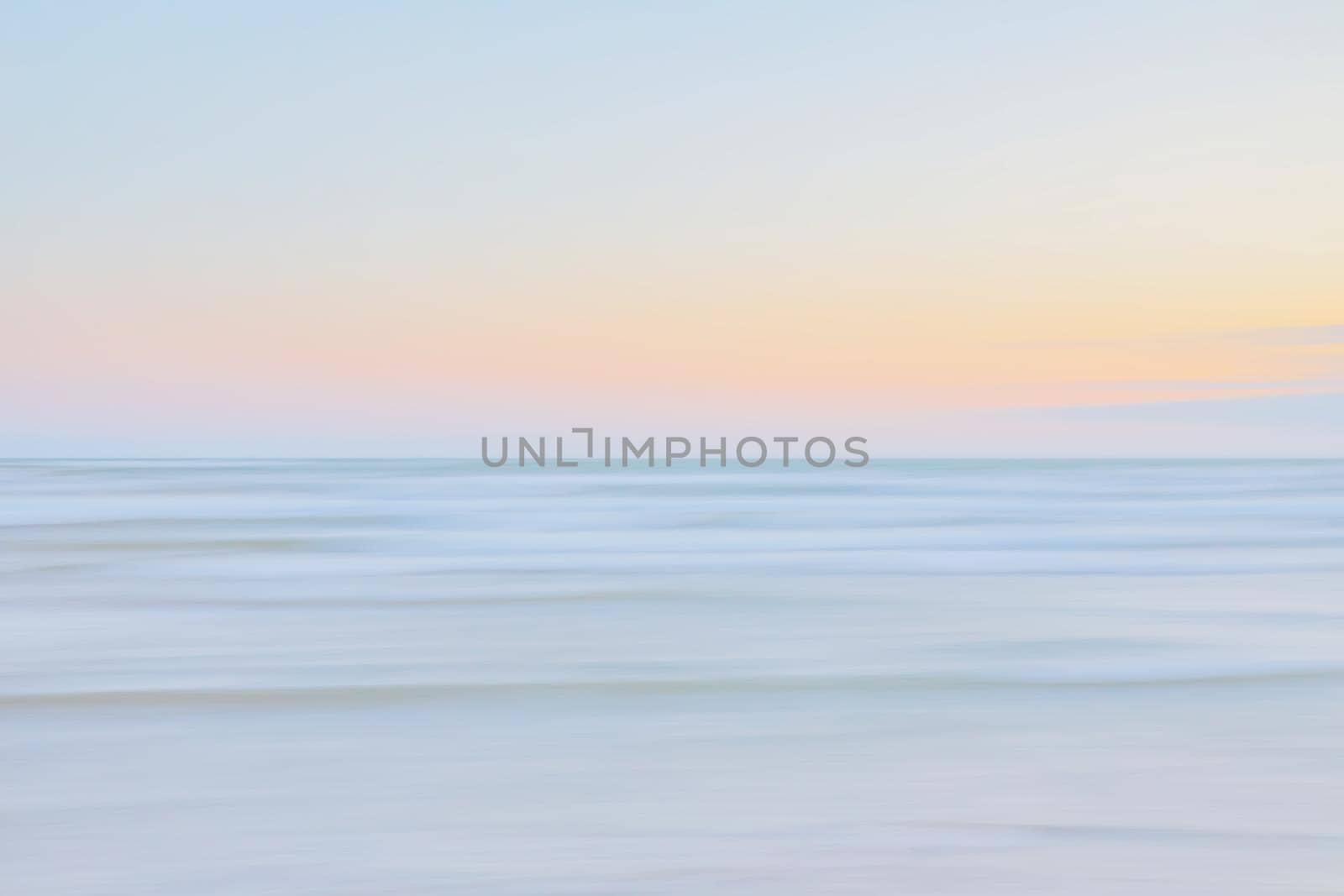 Abstract blurred sea landscape and cloudy sky background in light tonality with copy space