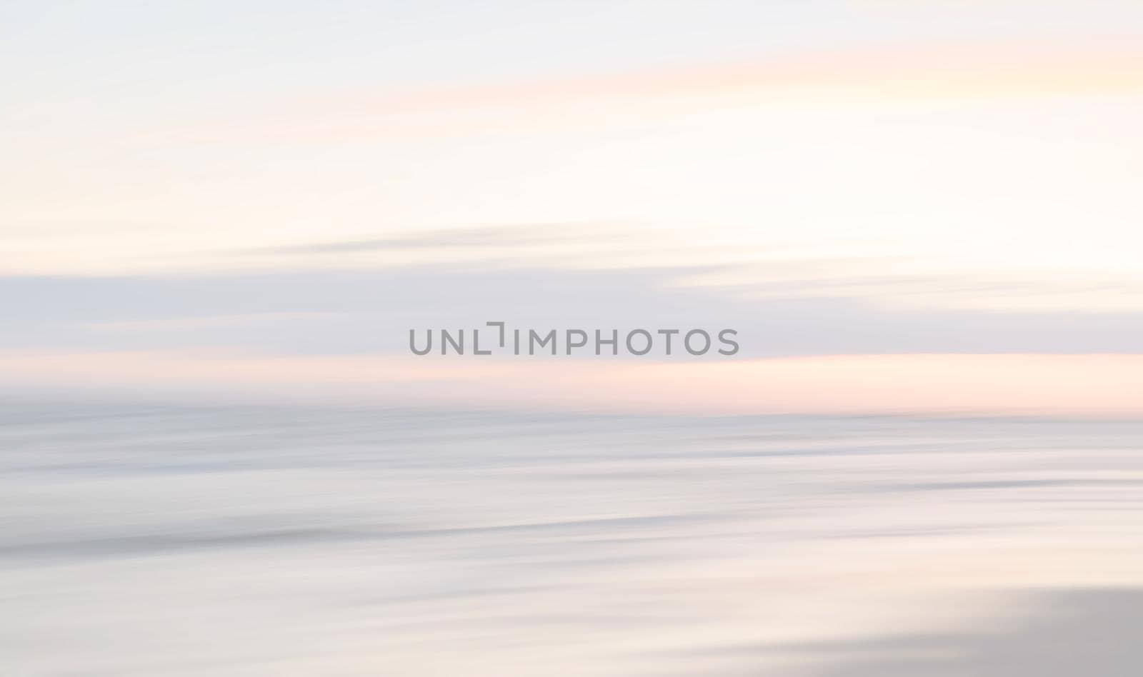 Abstract blurred sea landscape and cloudy sky background in light tonality with copy space