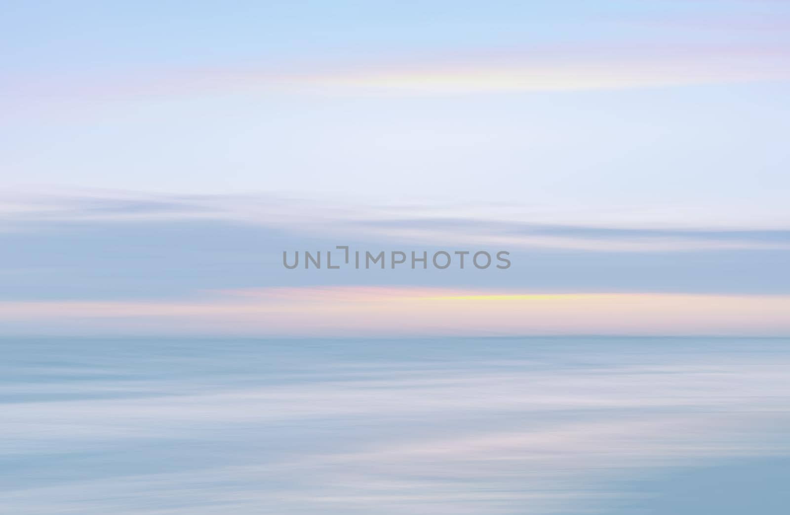 Abstract blurred sea landscape and cloudy sky background in light tonality with copy space
