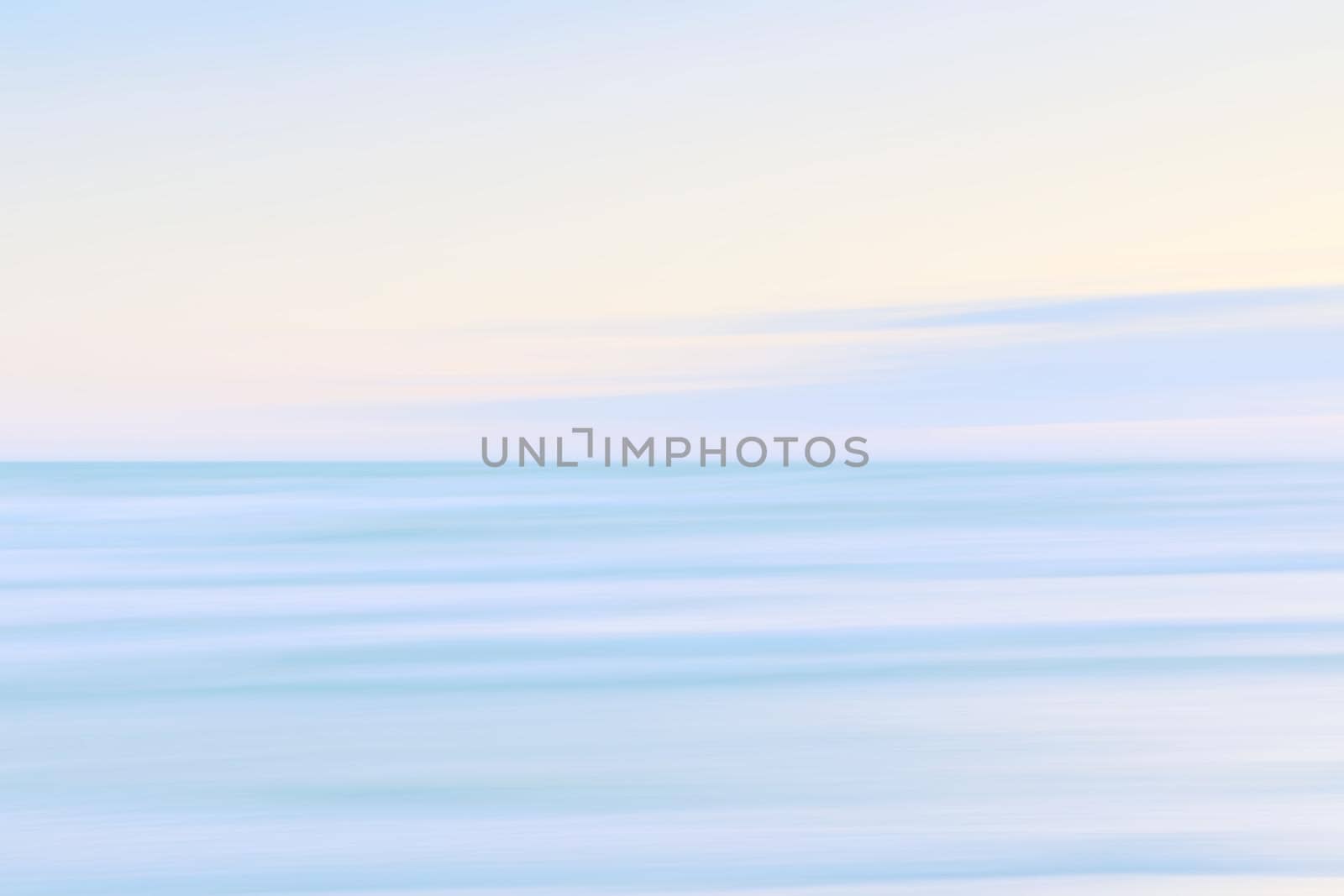 Abstract blurred sea landscape and cloudy sky background in light tonality with copy space