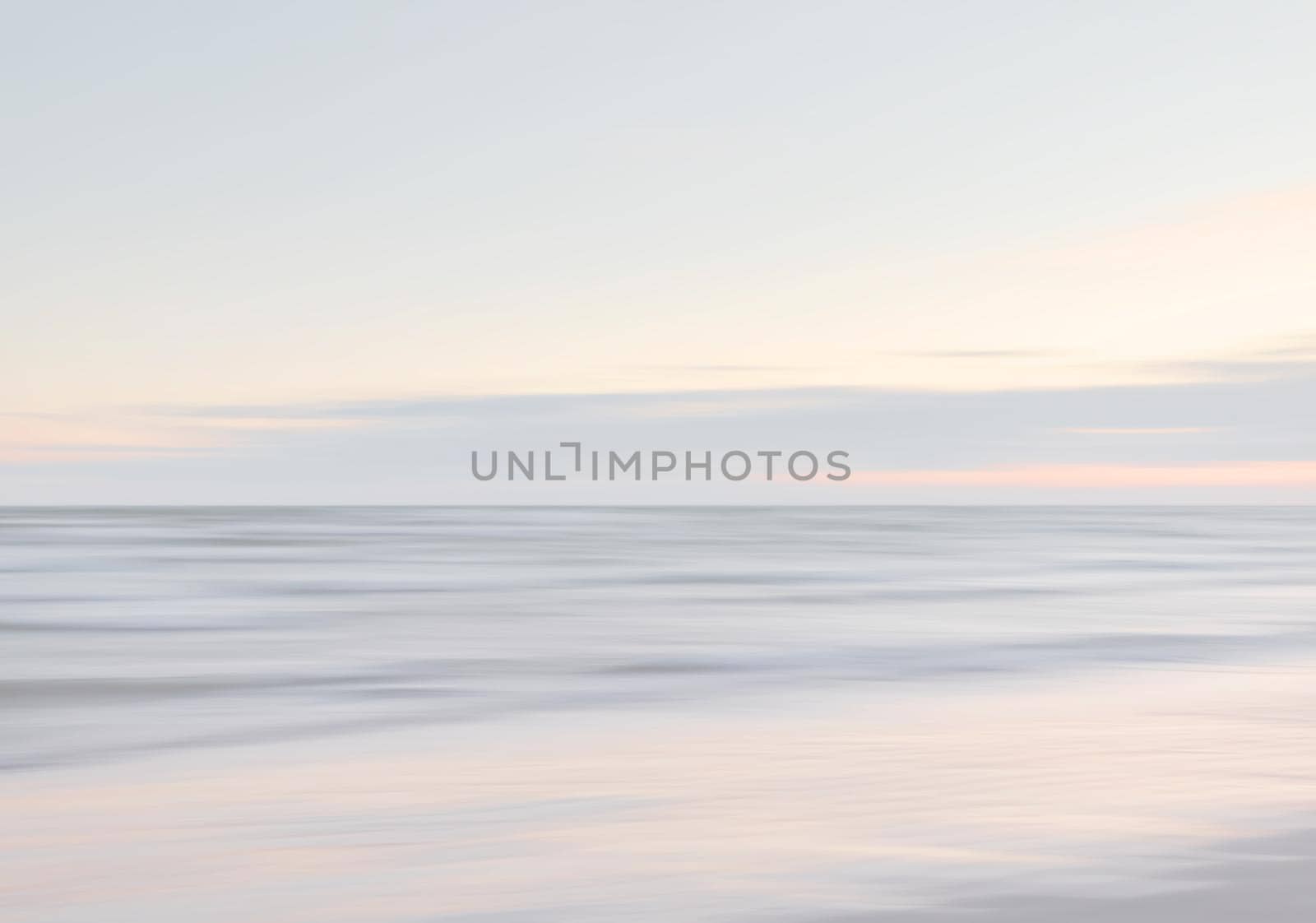Abstract blurred sea landscape and cloudy sky background in light tonality with copy space