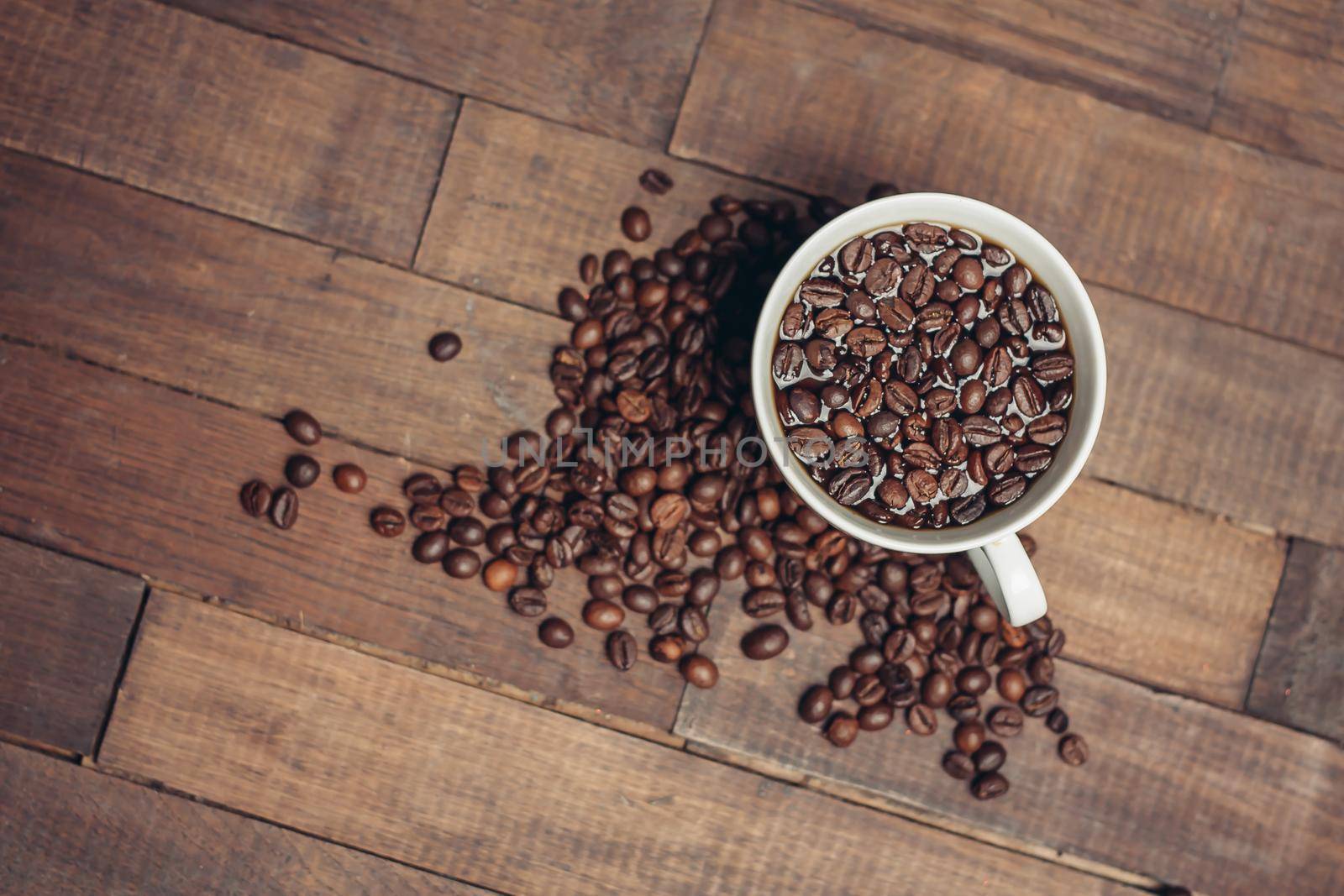 cup with coffee grains on a wooden table aromatic drink. High quality photo