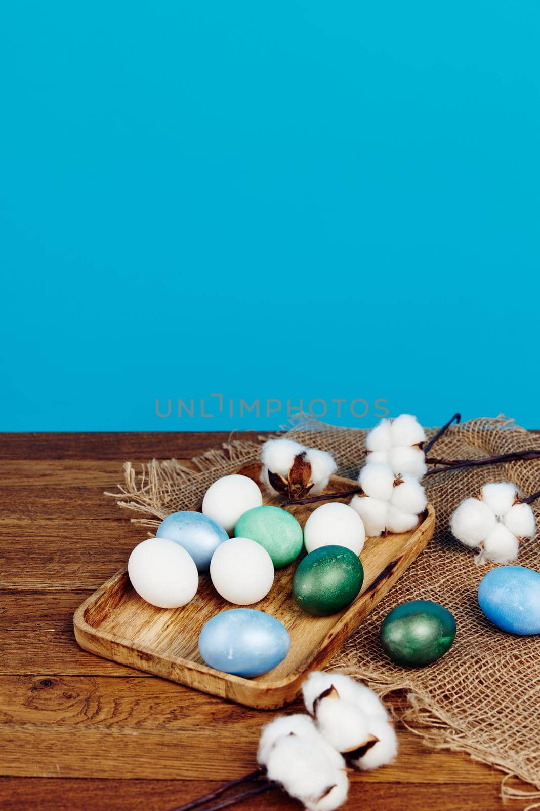 Easter eggs on a wooden board and blue background in the background . High quality photo