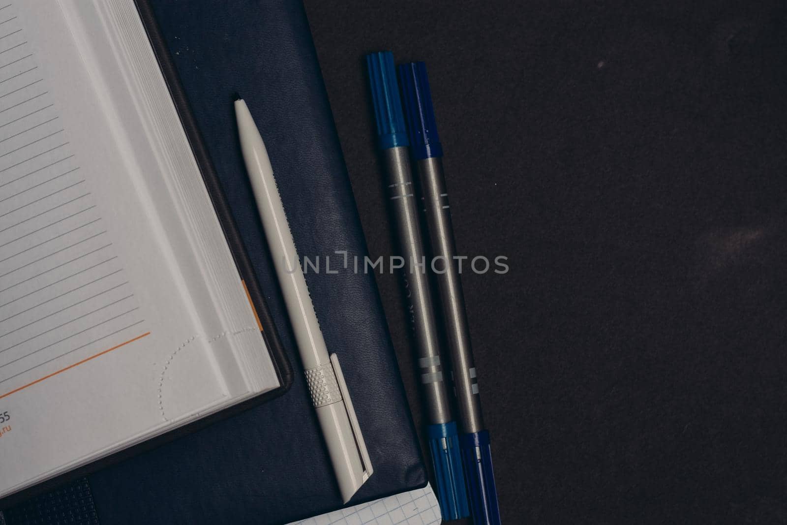 notepads pens office supplies desktop work gray background. High quality photo