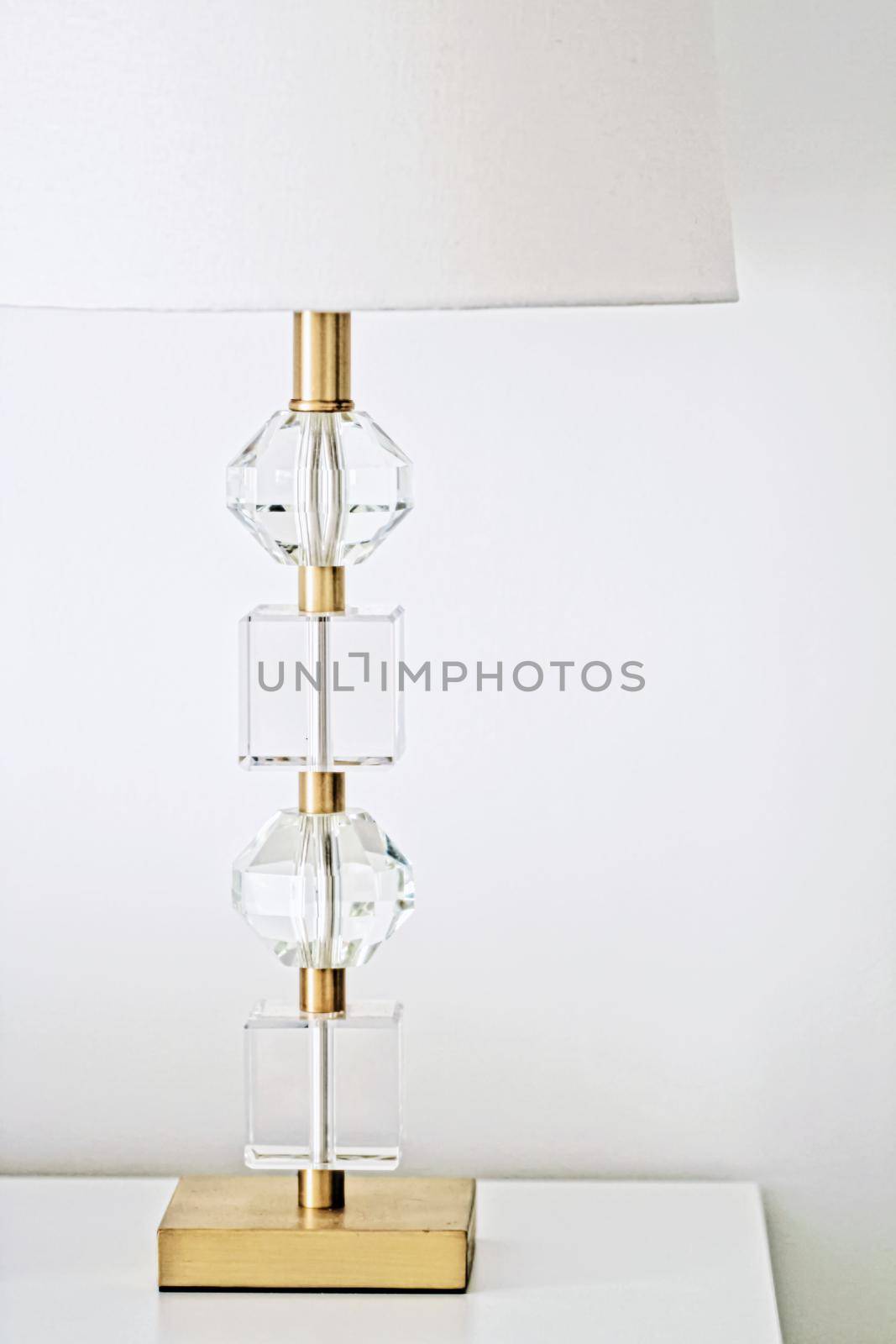 Lamp with gold and crystal design in white interior, luxury home decor concept