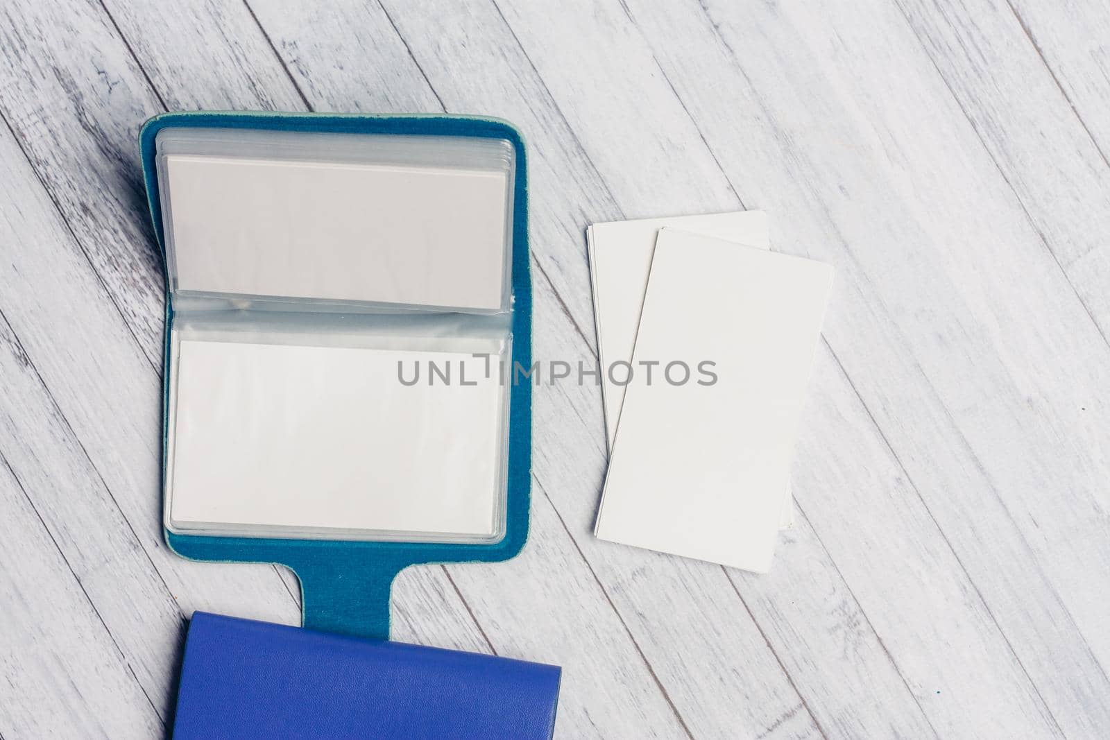 business card holder with letterheads on a wooden table top view Copy Space. High quality photo