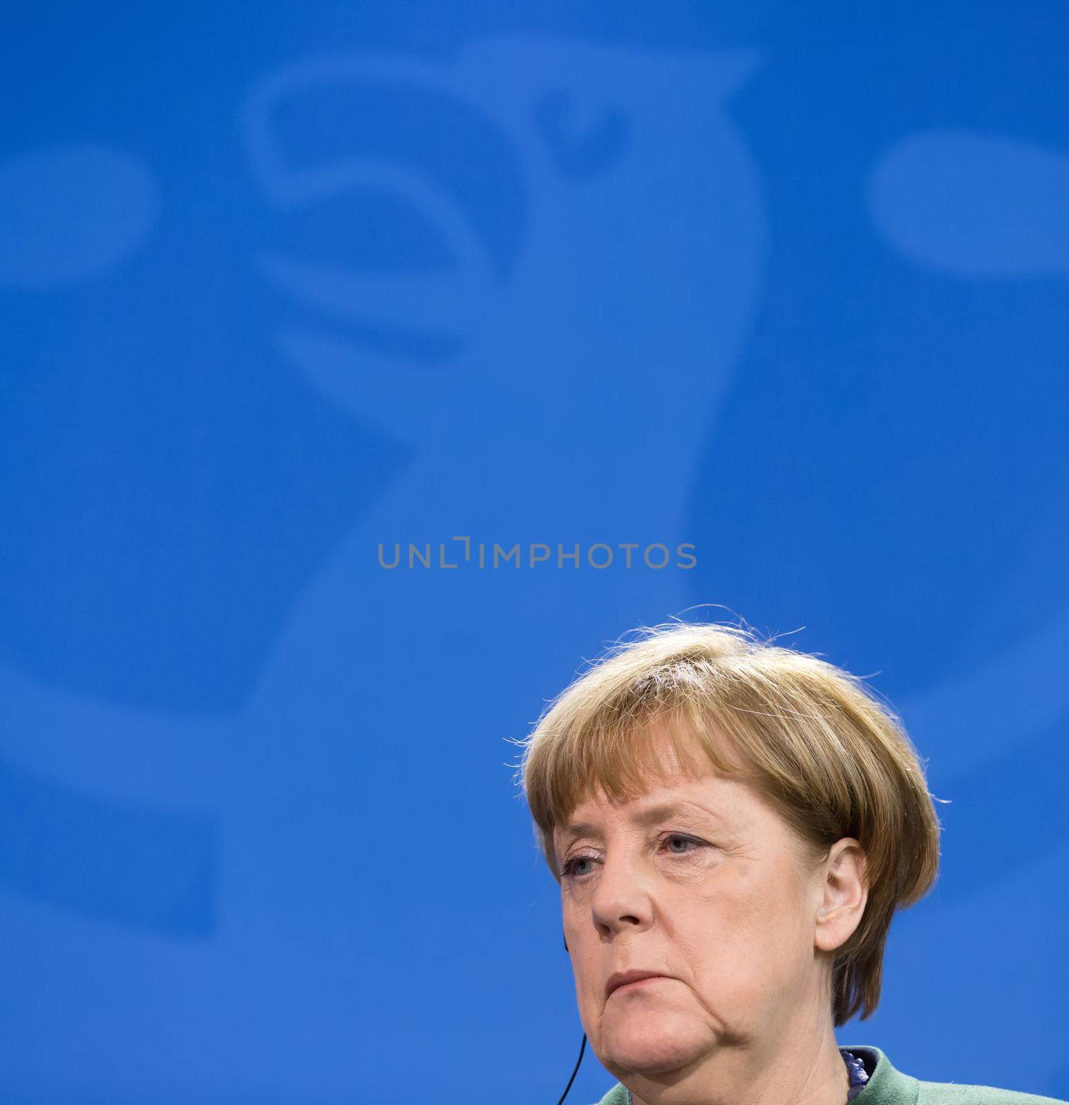 BERLIN, GERMANY - Jan 30, 2017: Chancellor of the Federal Republic of Germany Angela Merkel against of Germany coat of arms Imperial Eagle. Joint briefing with President of Ukraine Petro Poroshenko