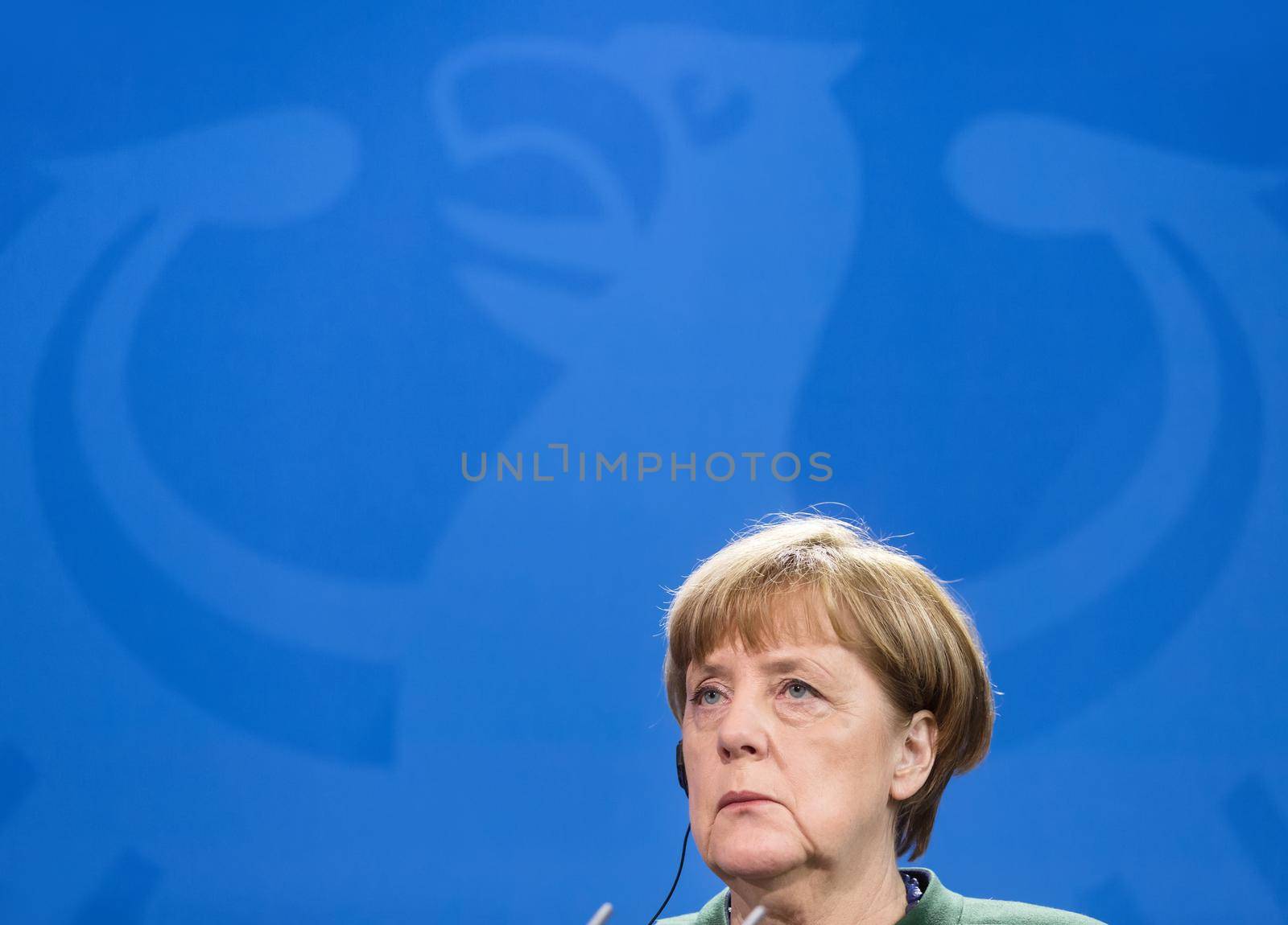 BERLIN, GERMANY - Jan 30, 2017: Chancellor of the Federal Republic of Germany Angela Merkel against of Germany coat of arms Imperial Eagle. Joint briefing with President of Ukraine Petro Poroshenko