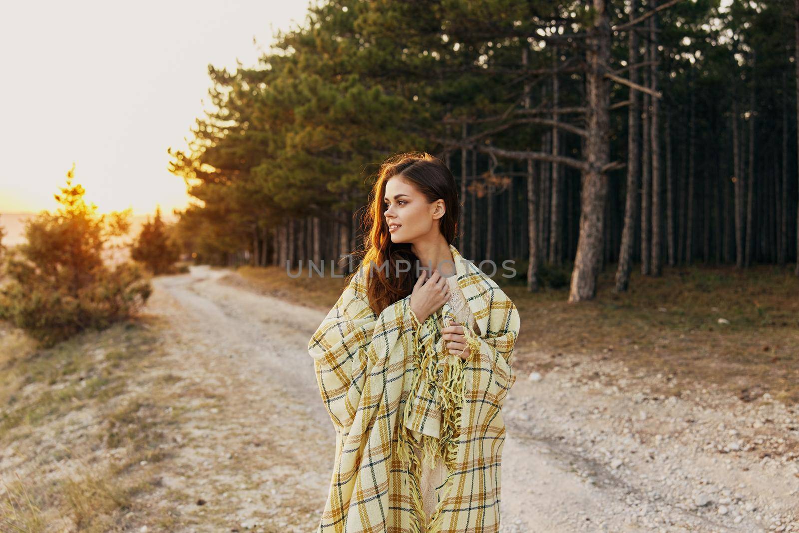 Woman health outdoors near coniferous forest at sunset. High quality photo