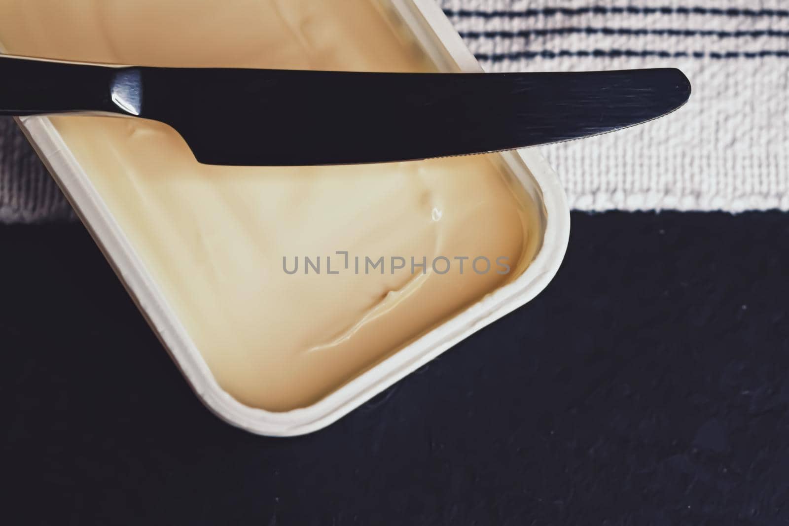 Soft spread butter and knife, breakfast food closeup