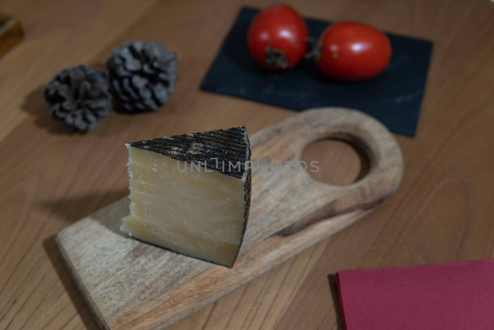 Cheese wedge with tomato and pineapple on wooden board by xavier_photo