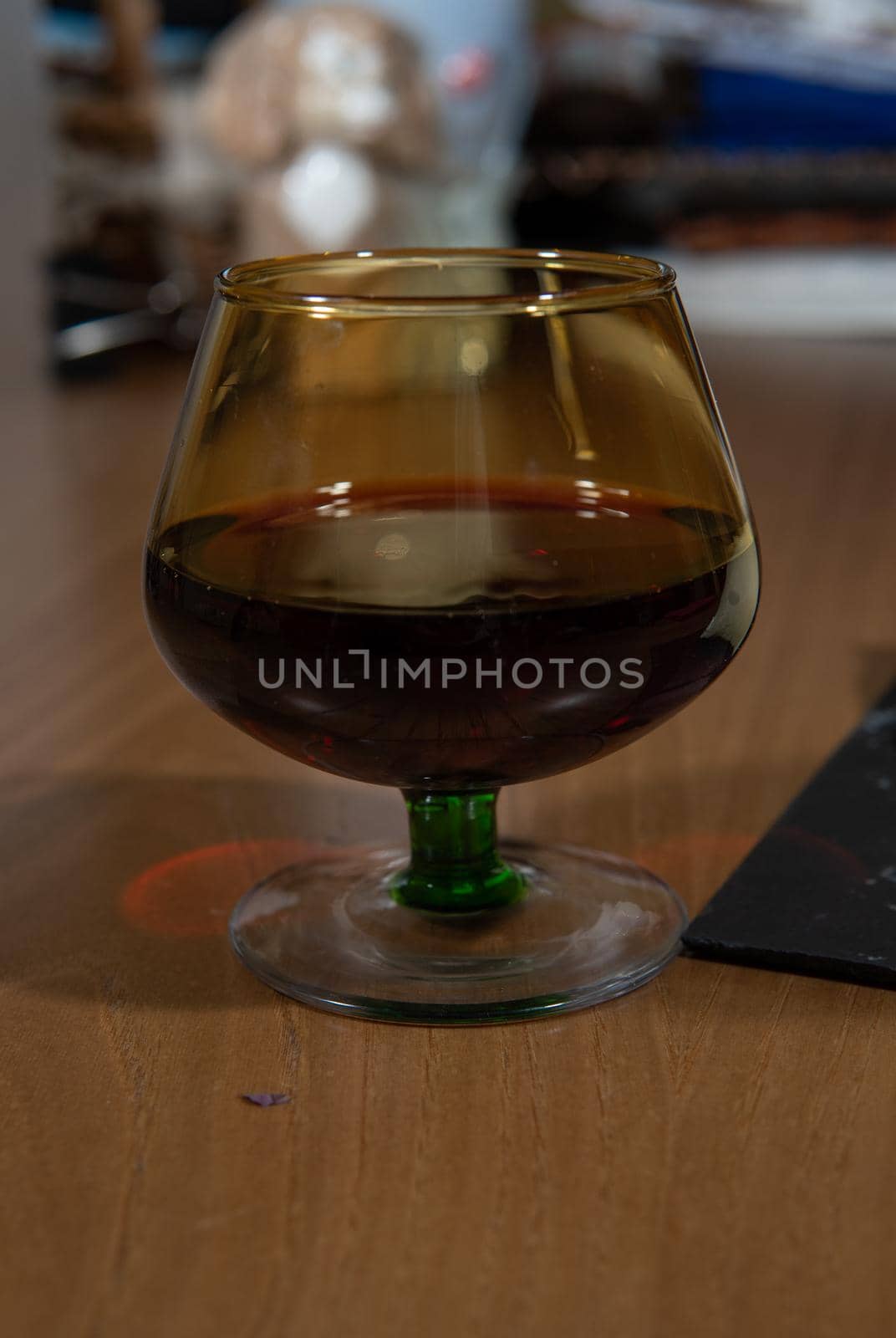 Wine glass on wooden table with beautiful shadows