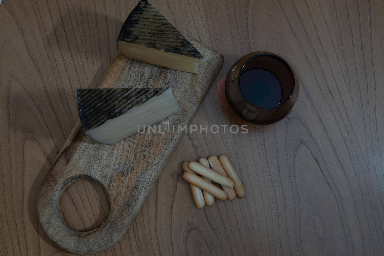 Cheese platter with wine and bread rolls