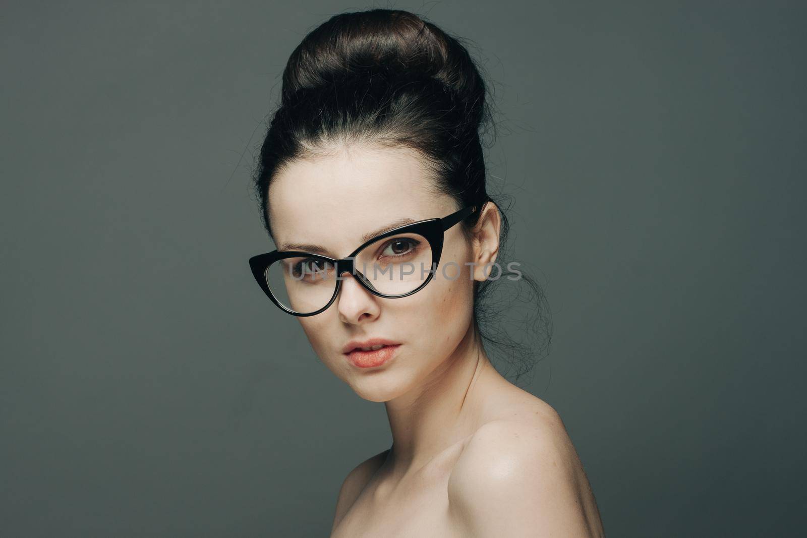 cute brunette with glasses naked shoulders gathered hair fashion by SHOTPRIME