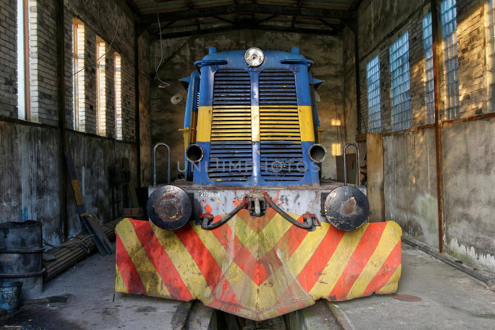 Old abandoned diesel locomotive in a former factory