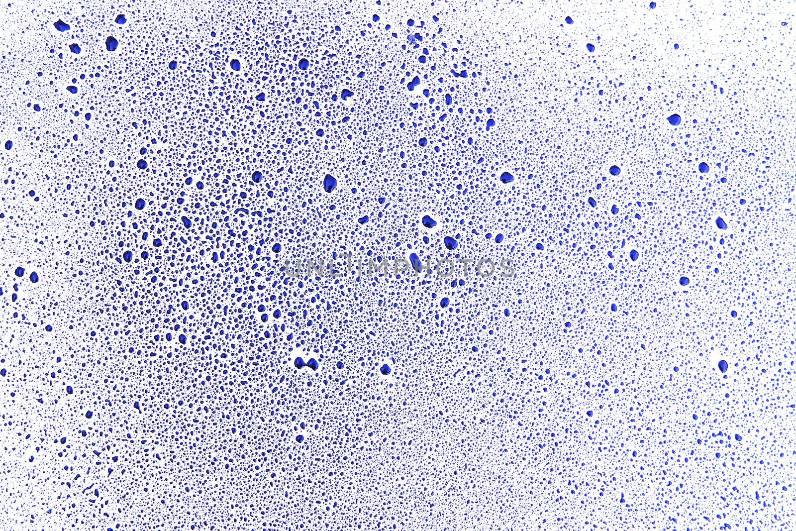 Detail of the drops of blue color on a white surface